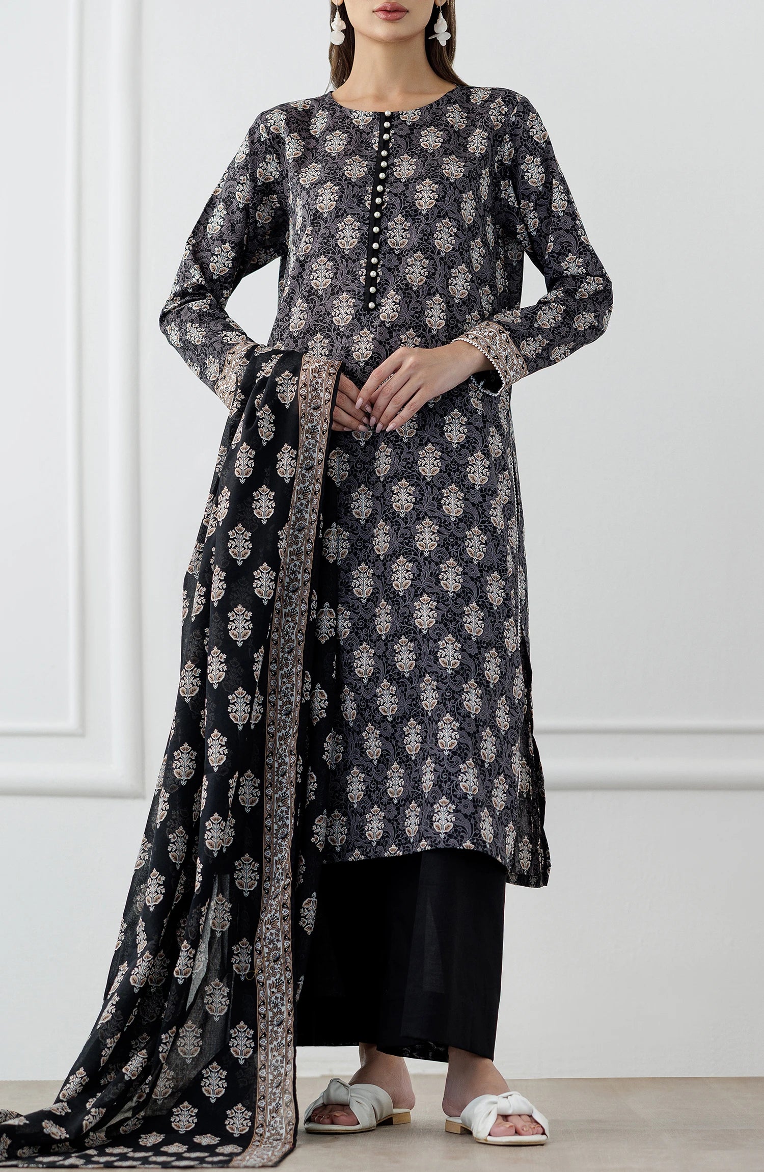 Woman wearing a black and white patterned kurta with a printed dupatta and against a dyed trouser. Stitched Printed Lawn Shirt Dupatta & Pant - 3 Piece Suits - OTL-25-105