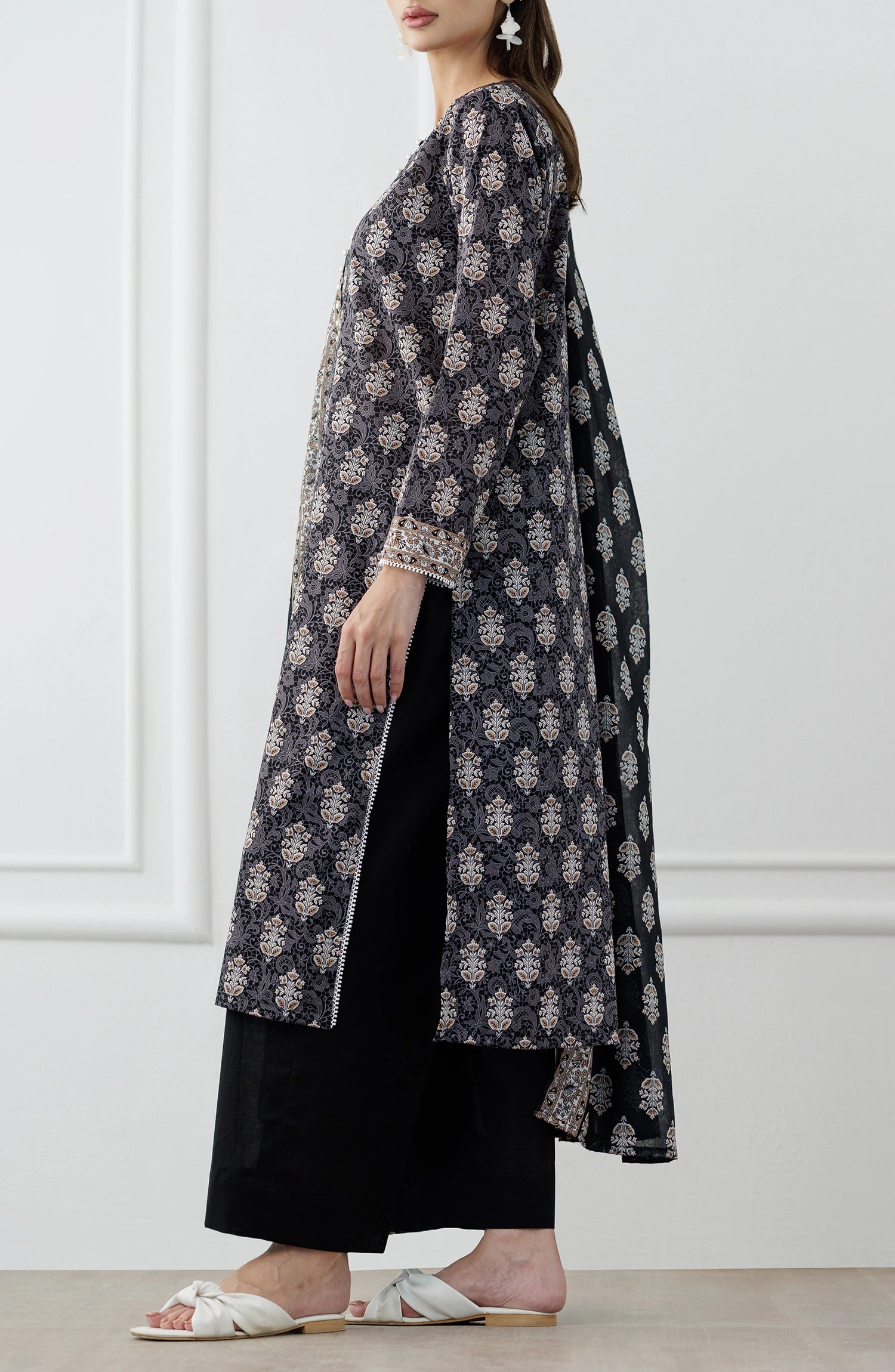 Woman wearing a black and white patterned kurta with a printed dupatta and against a dyed trouser. Stitched Printed Lawn Shirt Dupatta & Pant - 3 Piece Suits - OTL-25-105