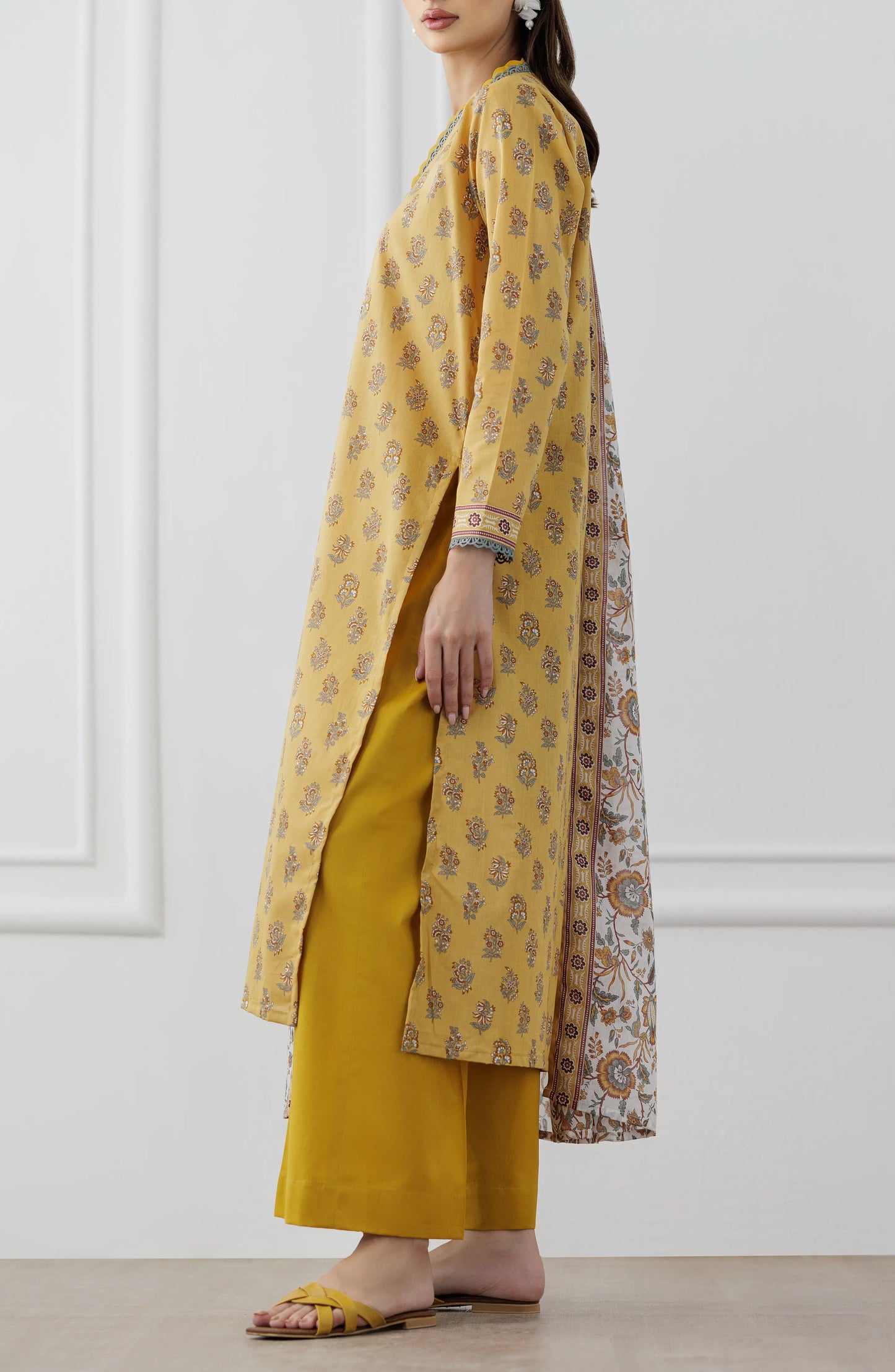 Woman wearing a mustard yellow floral dress with a matching dupatta on a plain trouser. Stitched Printed Lawn Shirt Dupatta & Pant - 3 Piece Suits - OTL-25-118