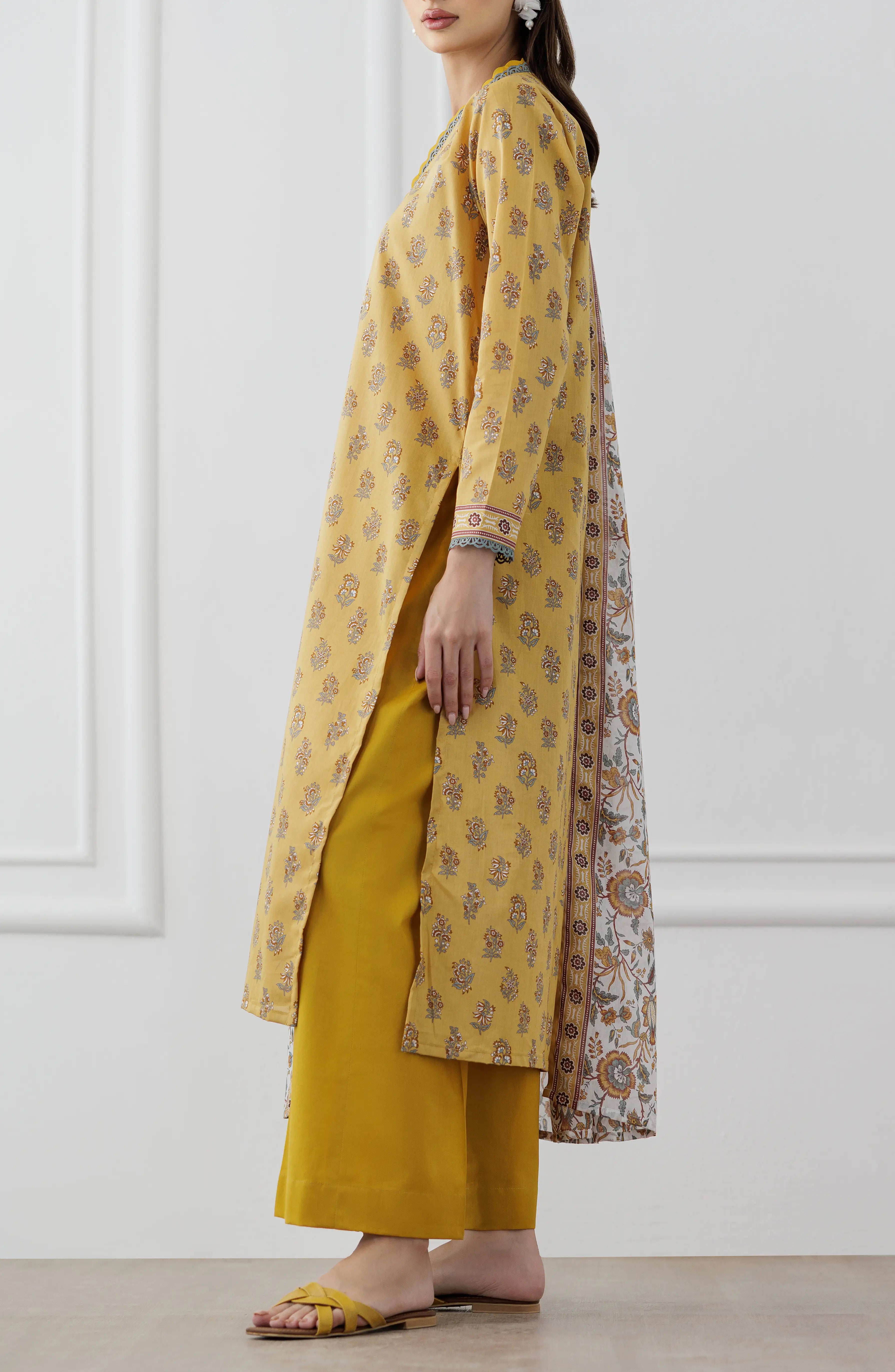 Woman wearing a mustard yellow kurta with a floral dupatta against a dyed trouser. Unstitched Printed Lawn Shirt Dupatta & Pant - 3 Piece Suits - OTL-25-118