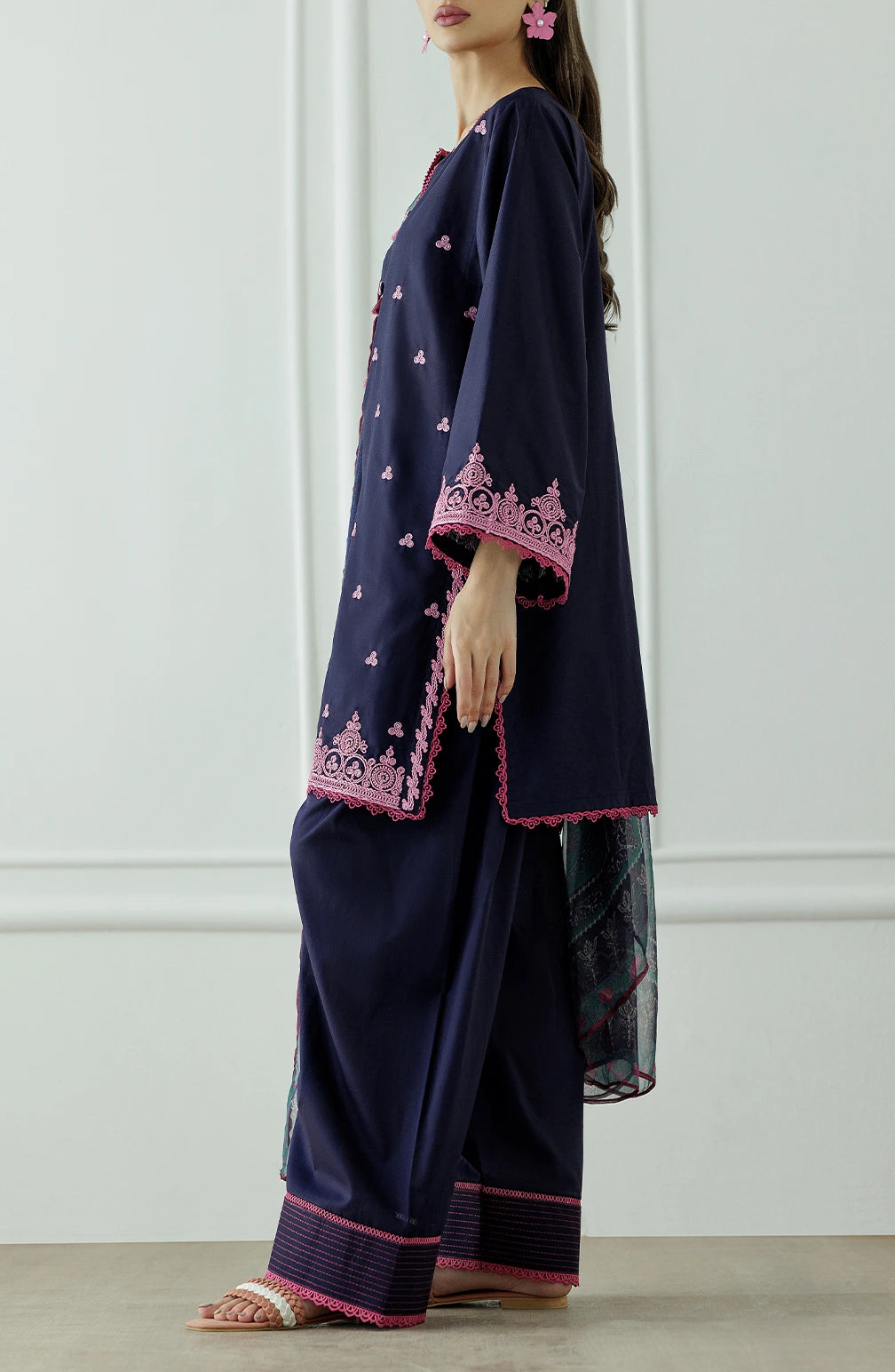 Woman wearing a navy blue traditional outfit with pink patterns, holding a matching dupatta and dyed trouser. Stitched Luxury Premium Embroidered Lawn Shirt Dupatta & Pant - 3 Piece Suits - OTL-25-132