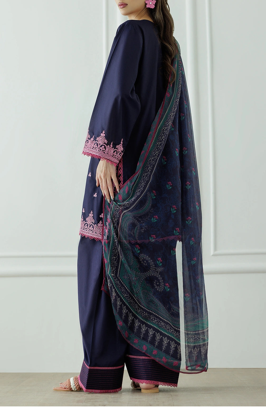 Woman wearing a navy blue traditional outfit with pink patterns, holding a matching dupatta and dyed trouser. Stitched Luxury Premium Embroidered Lawn Shirt Dupatta & Pant - 3 Piece Suits - OTL-25-132