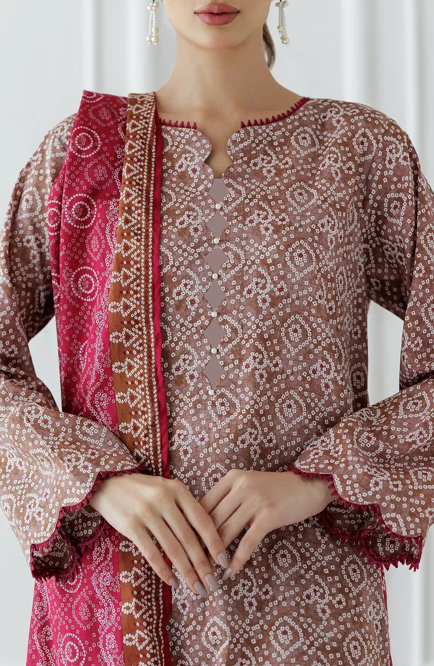 Woman wearing a patterned kurta with pants and a pink dupatta against a dyed trouser. Stitched Printed Lawn Shirt Dupatta & Pant - 3 Piece - OTL-25-308. 