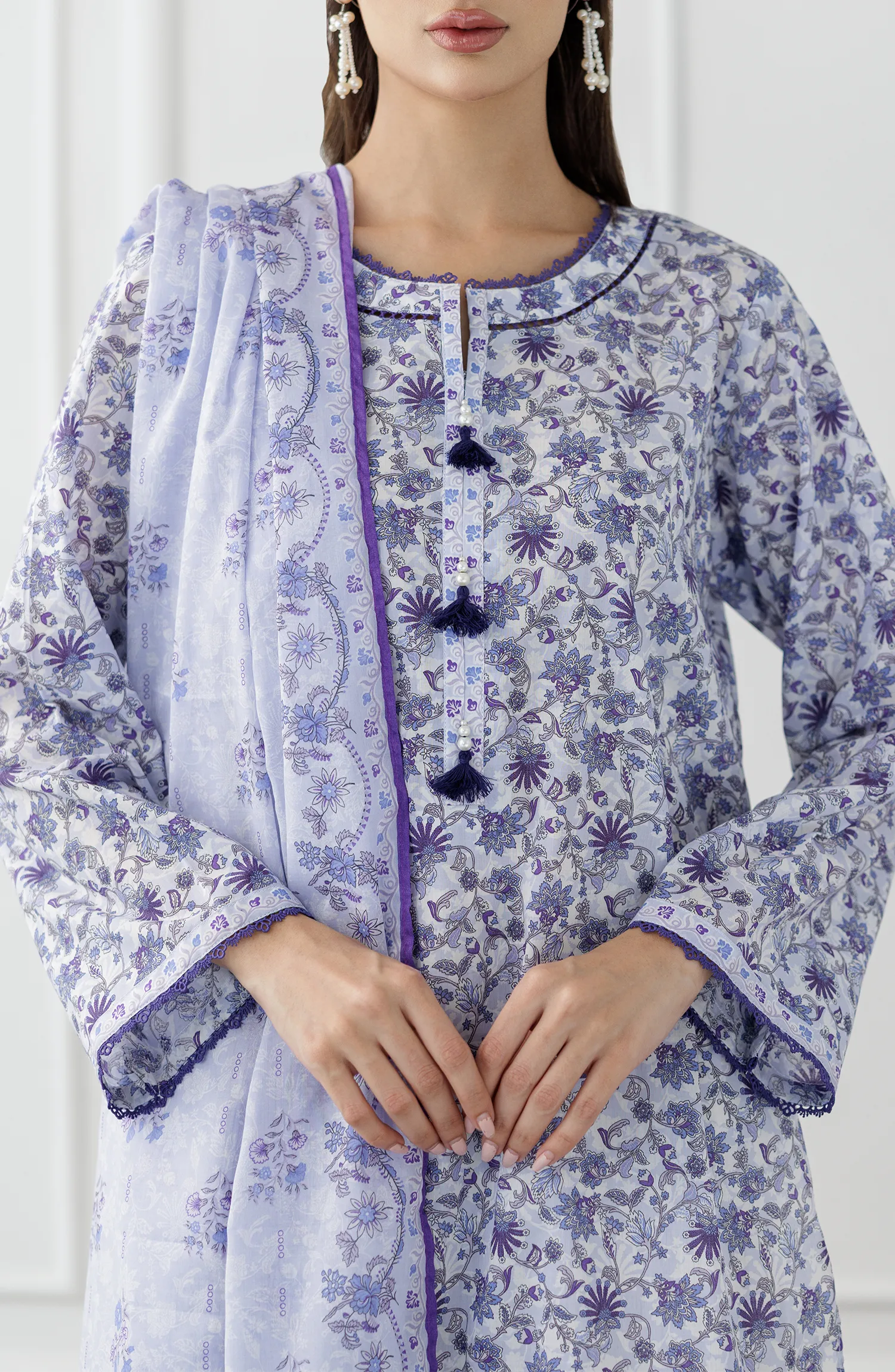 Woman wearing a blue and white floral outfit with a matching dupatta against a dyed trouser. Unstitched Printed Lawn Shirt Dupatta & Pant - 3 Piece Suits - OTL-25-312