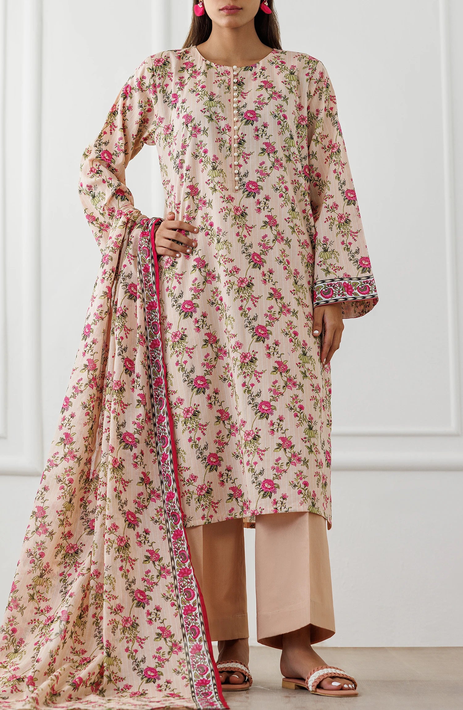 Woman wearing a floral dress with a matching dupatta against a matching trouser. Unstitched Printed Lawn Shirt Dupatta & Pant - 3 Piece Suits - OTL-25-319