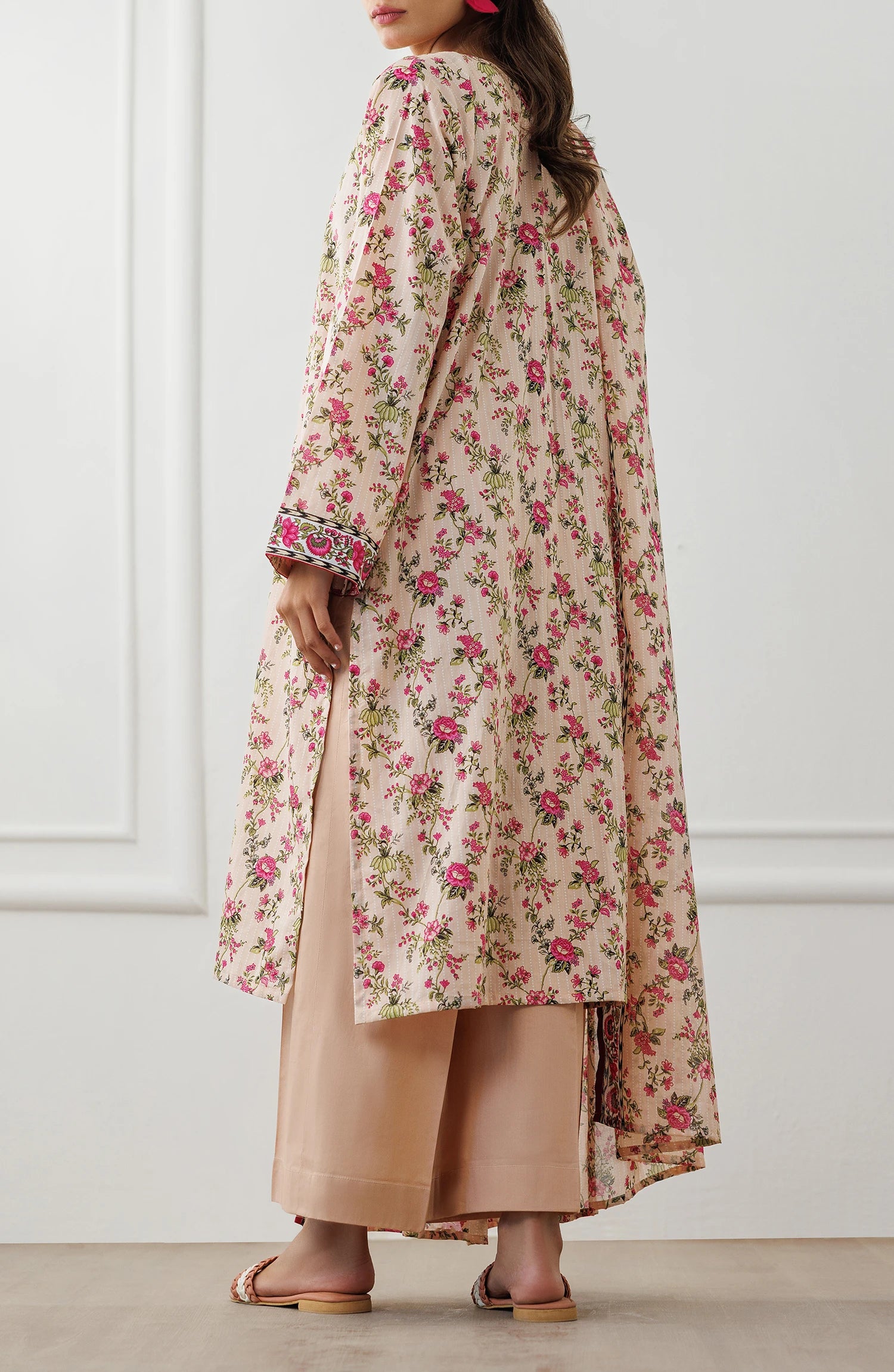 Woman wearing a floral dress with a matching dupatta against a plain trouser. Stitched Printed Lawn Shirt Dupatta & Pant - 3 Piece Suits - OTL-25-319