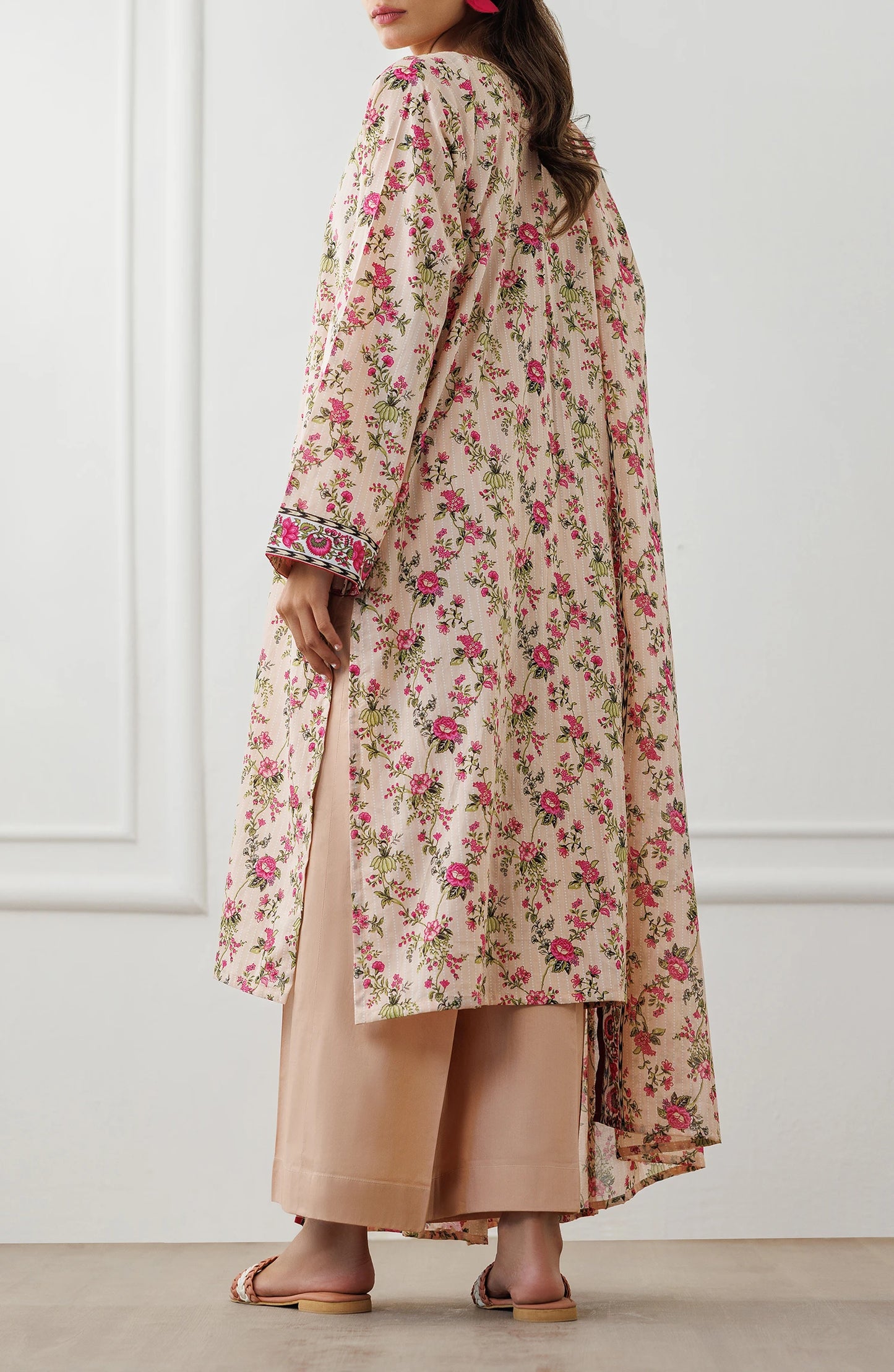 Woman wearing a floral dress with a matching dupatta against a plain trouser. Stitched Printed Lawn Shirt Dupatta & Pant - 3 Piece Suits - OTL-25-319