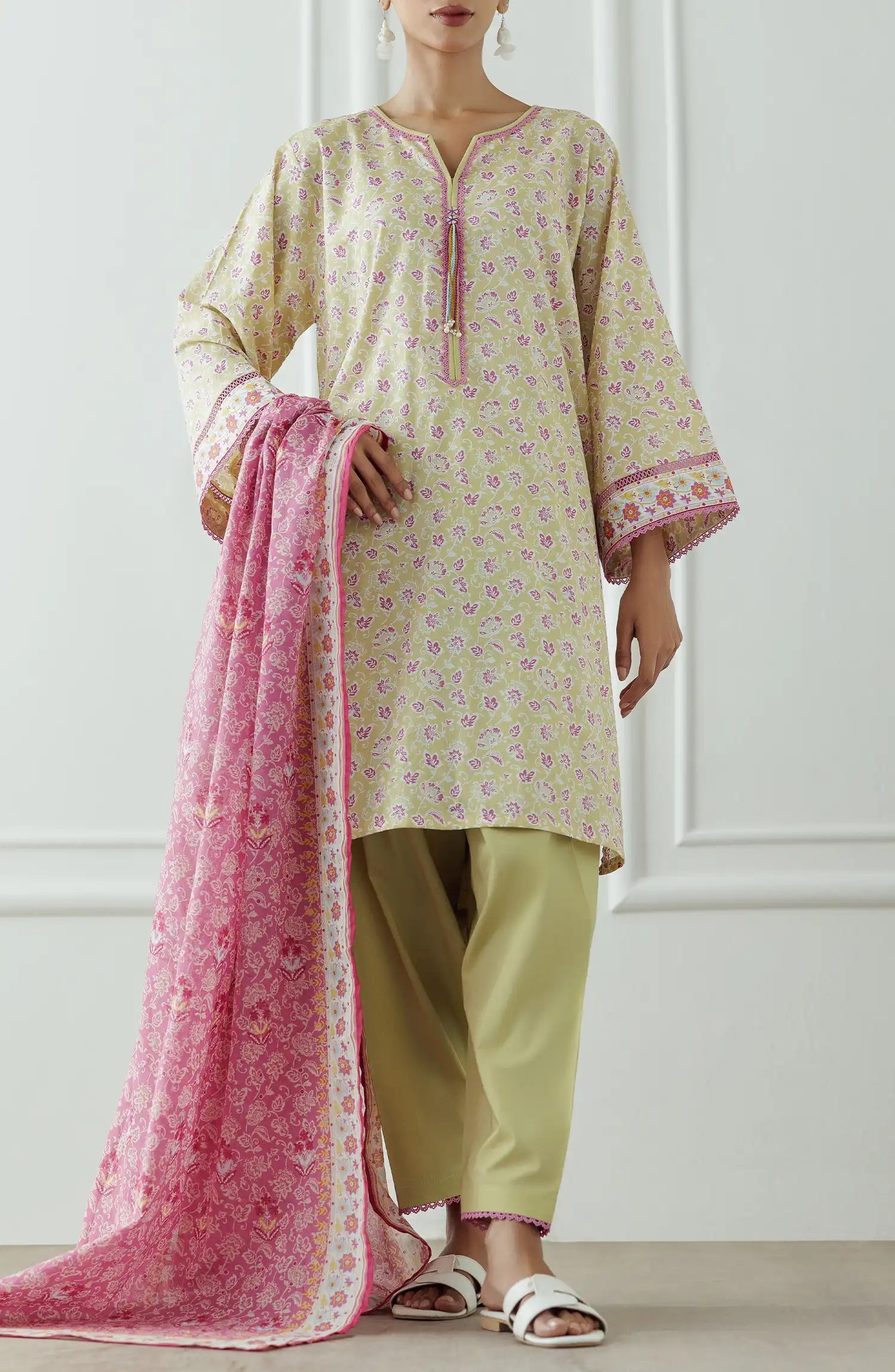 Woman wearing a traditional outfit with a floral kurta, pants, and pink dupatta against a plain trouser. Stitched Printed Lawn Shirt Dupatta & Pant - 3 Piece Suits - OTL-25-330