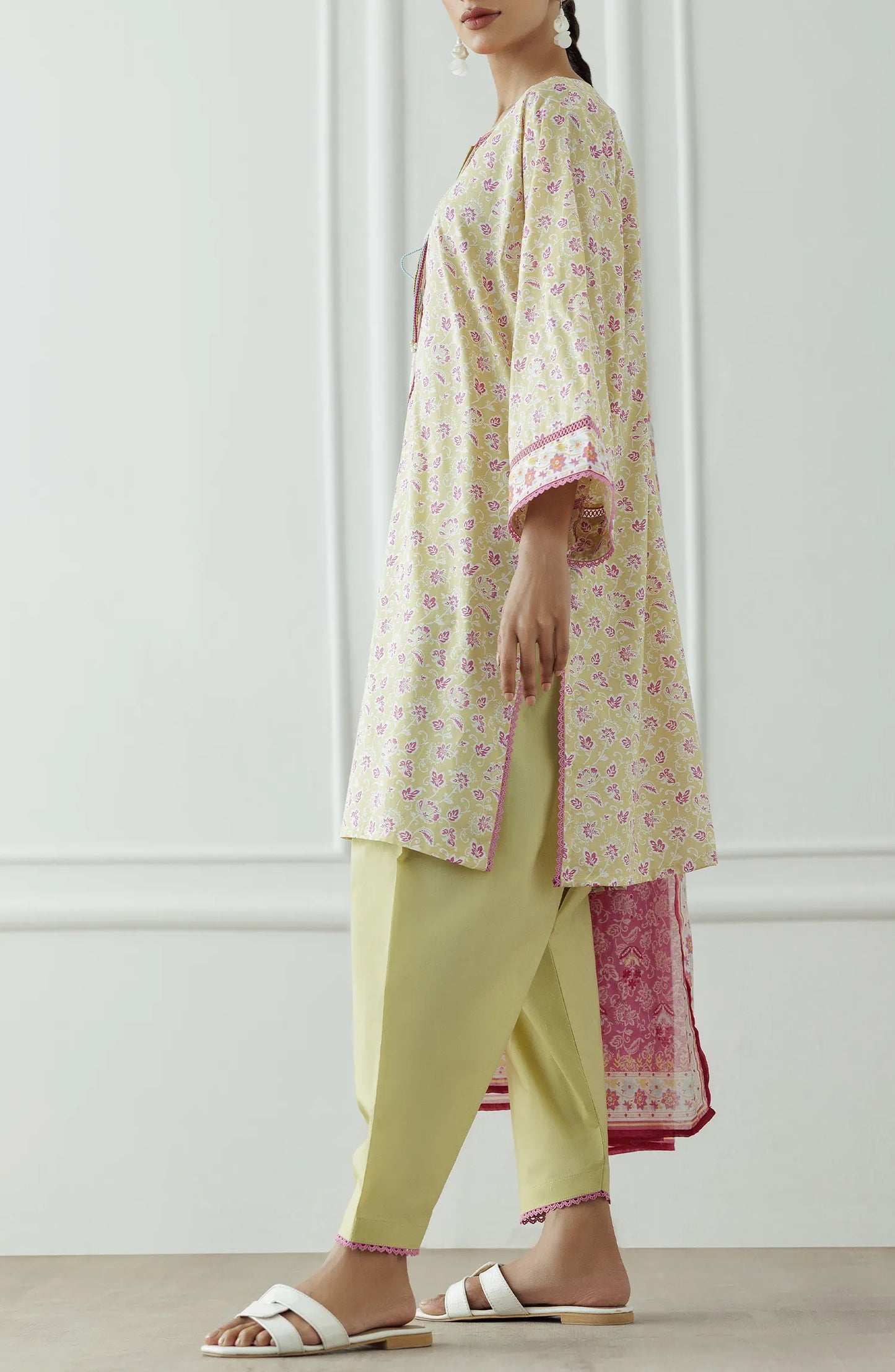Woman wearing a traditional outfit with a floral kurta, pants, and pink dupatta against a plain trouser. Stitched Printed Lawn Shirt Dupatta & Pant - 3 Piece Suits - OTL-25-330