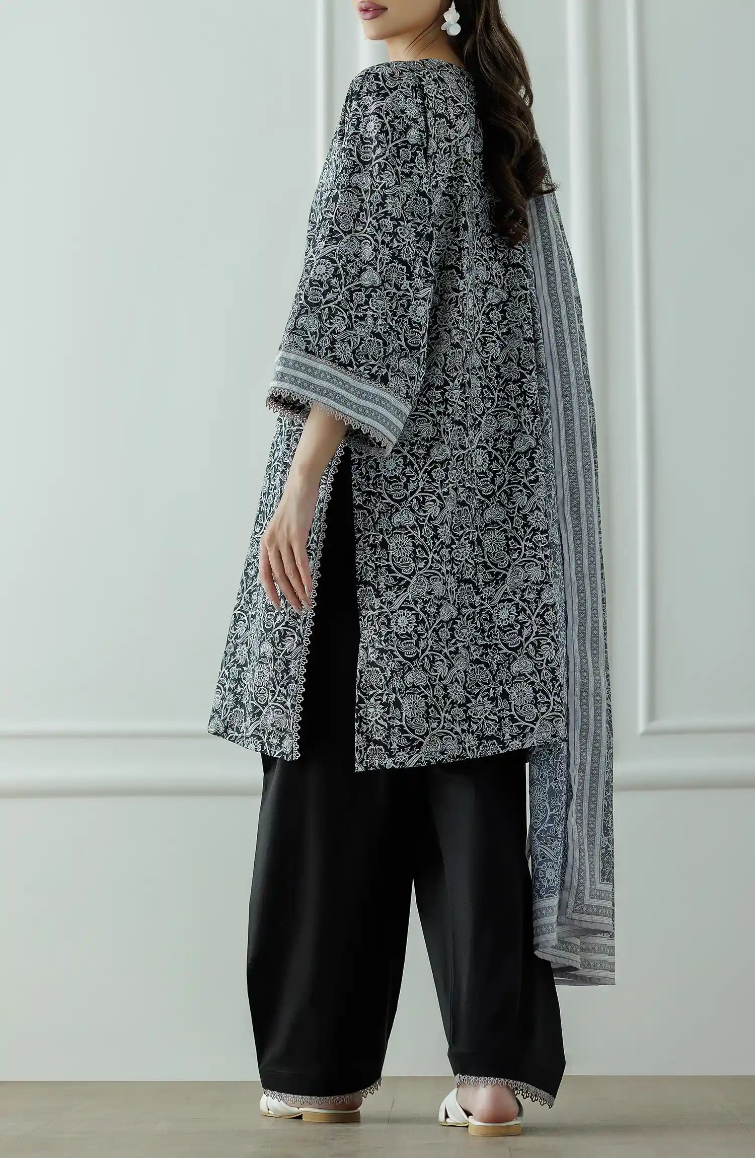 Stitched Printed Lawn Shirt Dupatta & Pant - 3 Piece - OTL-25-331. Woman wearing a black and white patterned kurta with black pants and a long black and white dupatta and black trouser.
