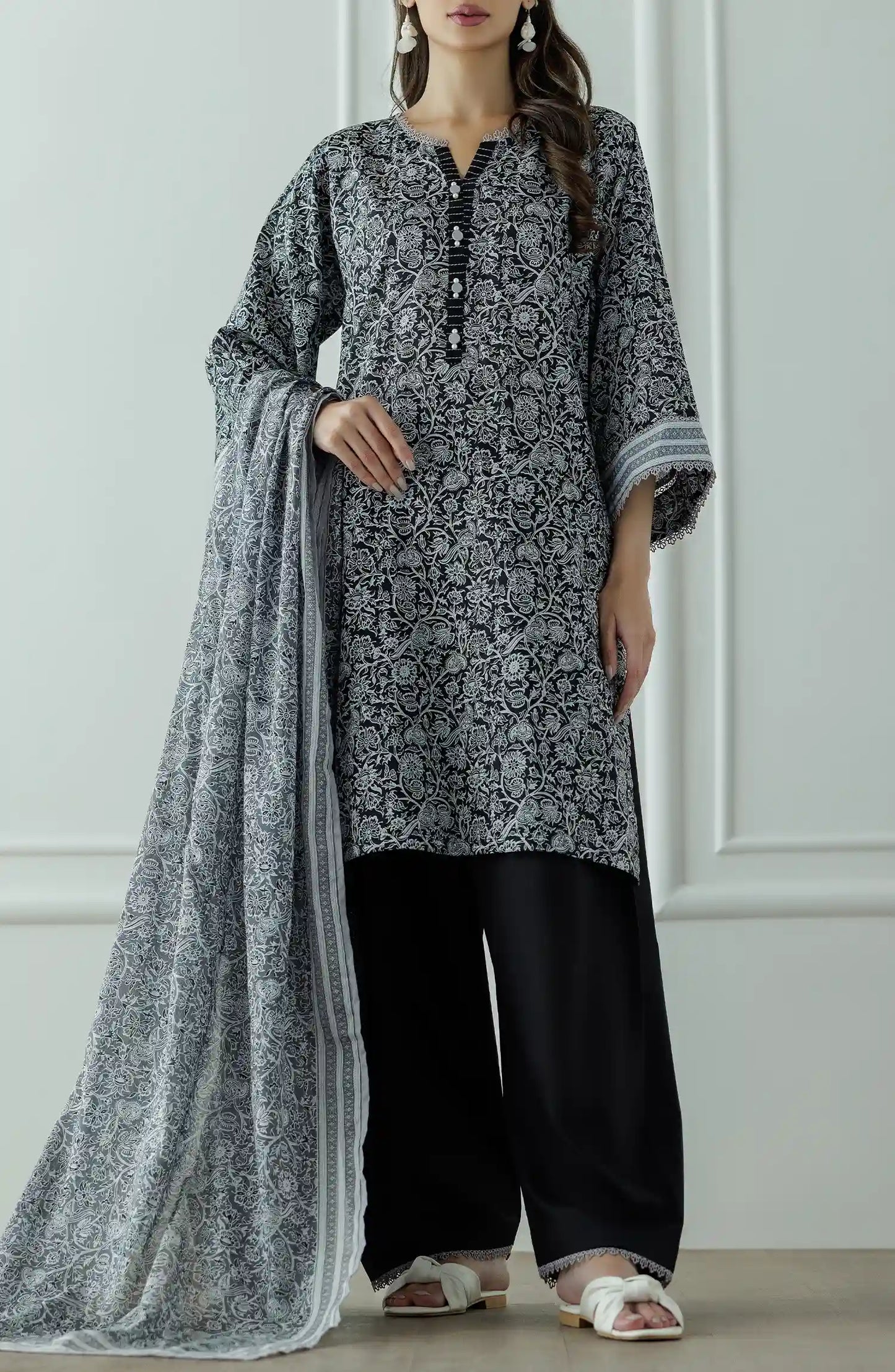 Stitched Printed Lawn Shirt Dupatta & Pant - 3 Piece - OTL-25-331. Woman wearing a black and white patterned kurta with black pants and a long black and white dupatta and black trouser.