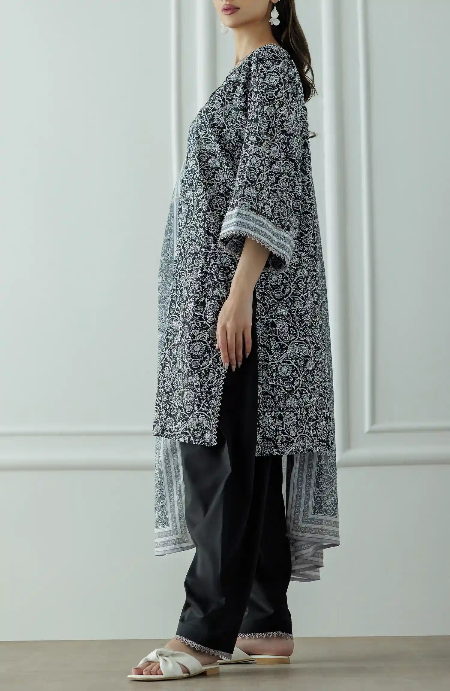 Stitched Printed Lawn Shirt Dupatta & Pant - 3 Piece - OTL-25-331. Woman wearing a black and white patterned kurta with black pants and a long black and white dupatta and black trouser.