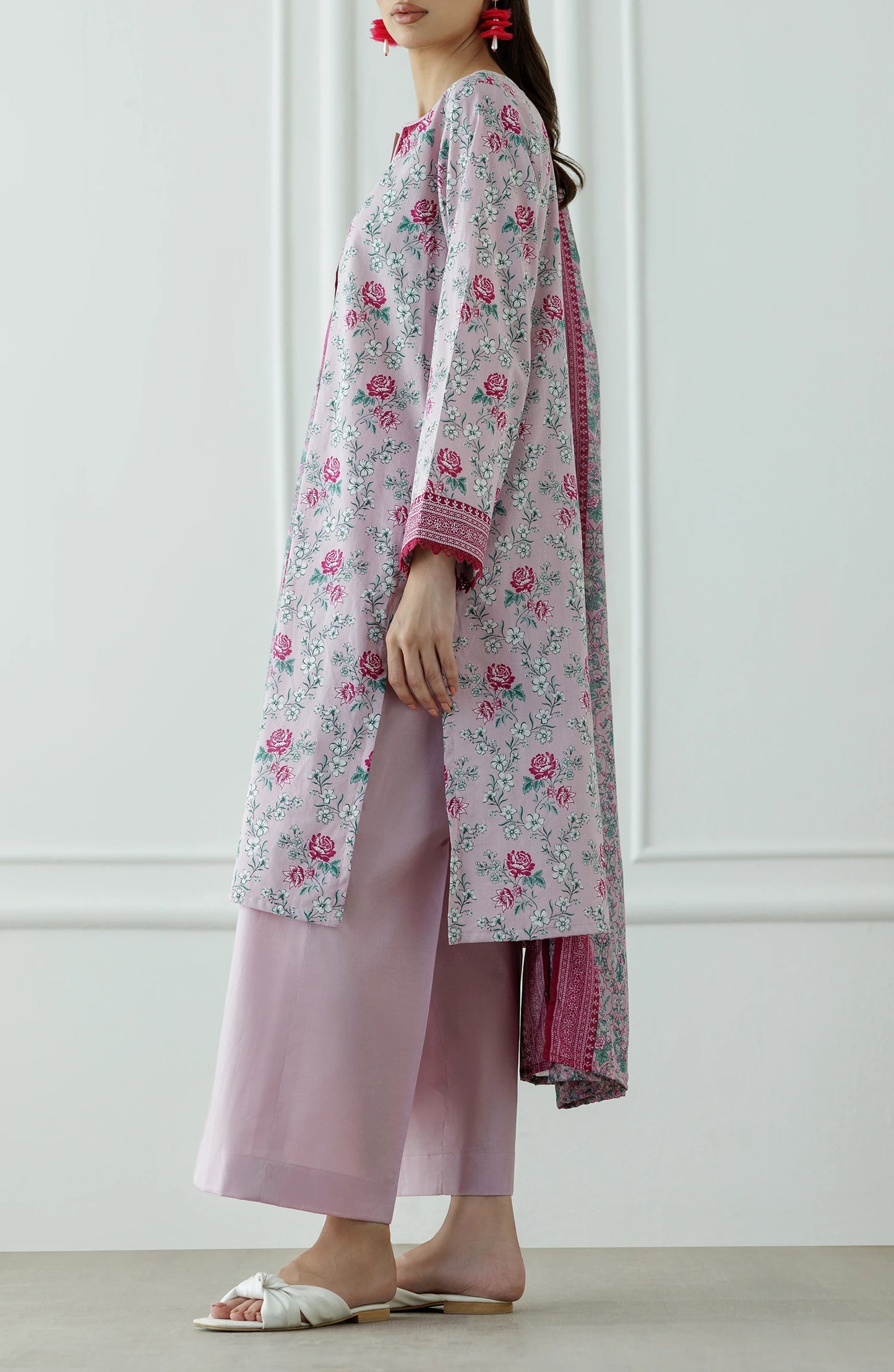 Woman wearing a floral kurta with pink border and matching pants against a dyed trouser. Stitched Printed Lawn Shirt Dupatta & Pant - 3 Piece Suits - OTL-25-337