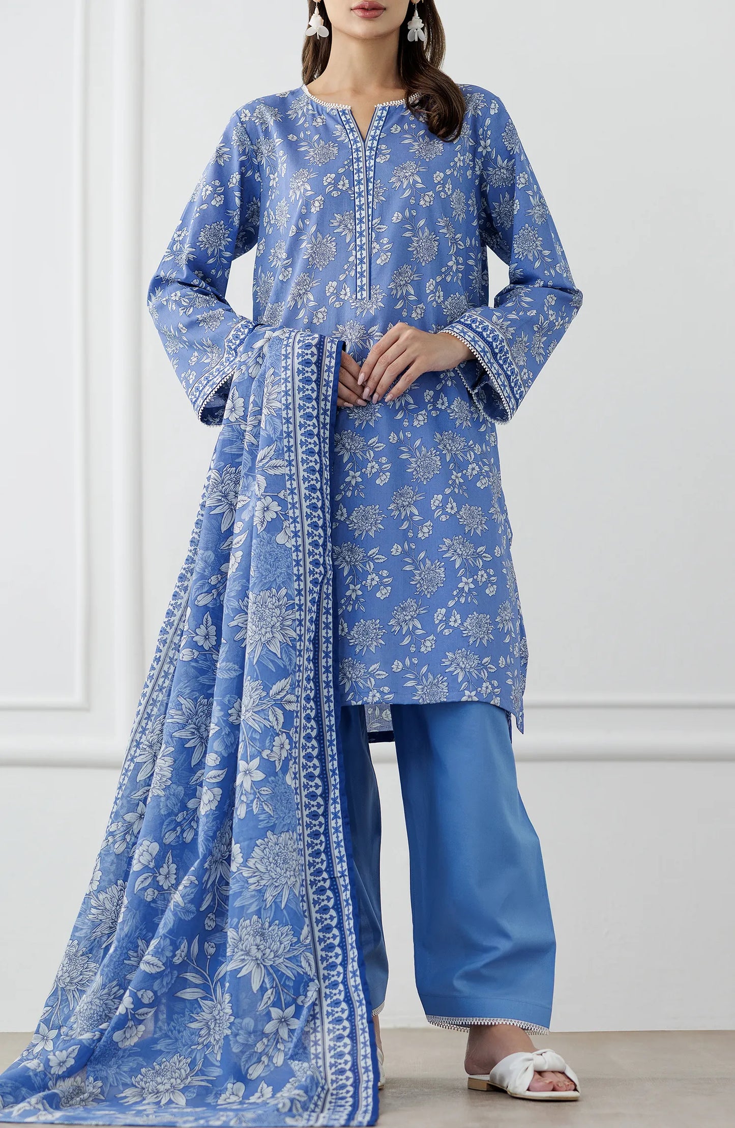 Woman wearing a blue embroidered outfit with a matching dupatta on a dyed trouser. Stitched Printed Lawn Shirt Dupatta & Pant - 3 Piece Suits - OTL-25-338