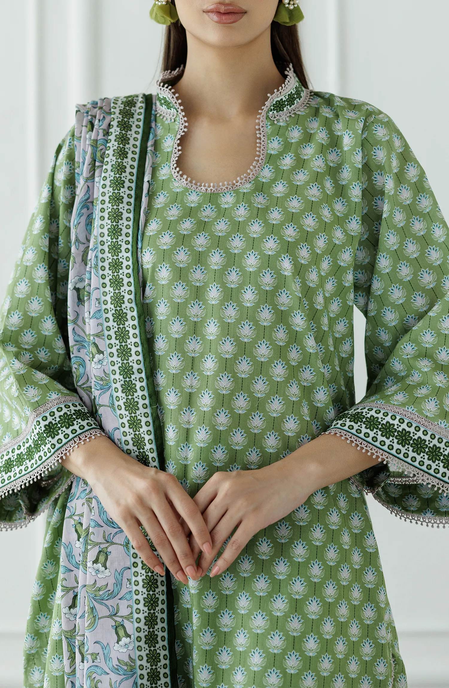 Woman wearing a green and white patterned outfit with a matching dupatta on a plain shalwar. Unstitched Printed Lawn Shirt Dupatta & Pant - 3 Piece Suits - OTL-25-339