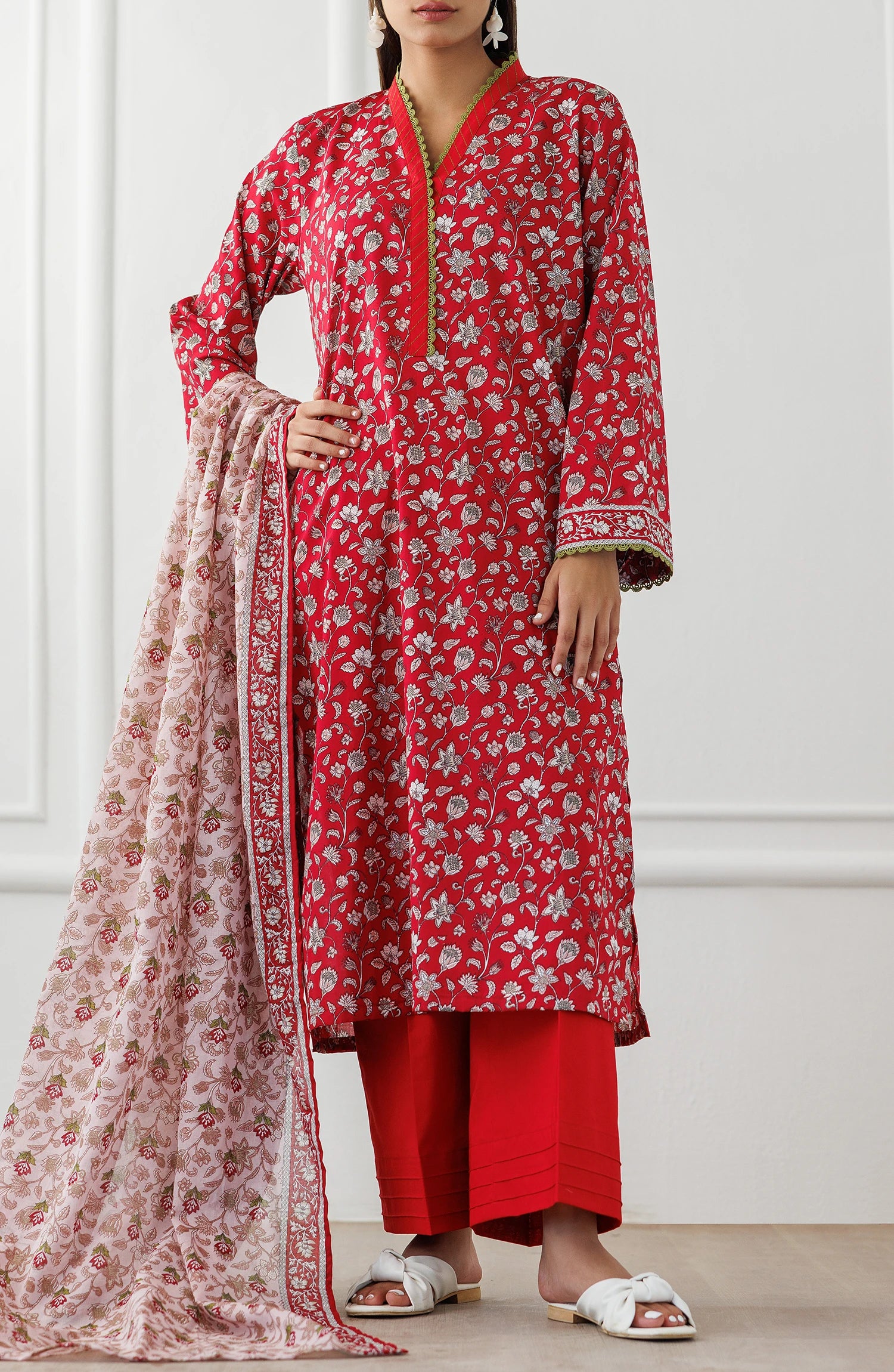 Woman wearing a red floral kurta with red pants and a matching dupatta on a matching trouser. Unstitched Printed Lawn Shirt Dupatta & Pant - 3 Piece Suits - OTL-25-344