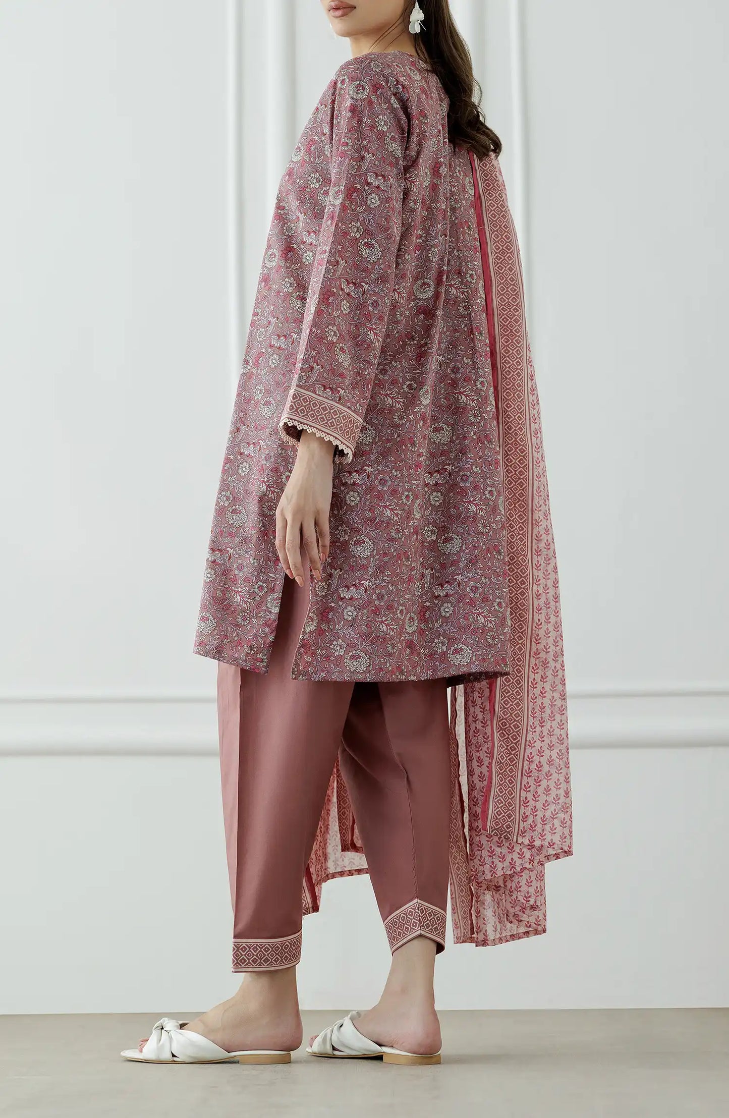 Woman wearing a pink traditional outfit with a matching dupatta against a traditional shalwar. Stitched Printed Lawn Shirt Dupatta & Pant - 3 Piece Suits - OTL-25-345
