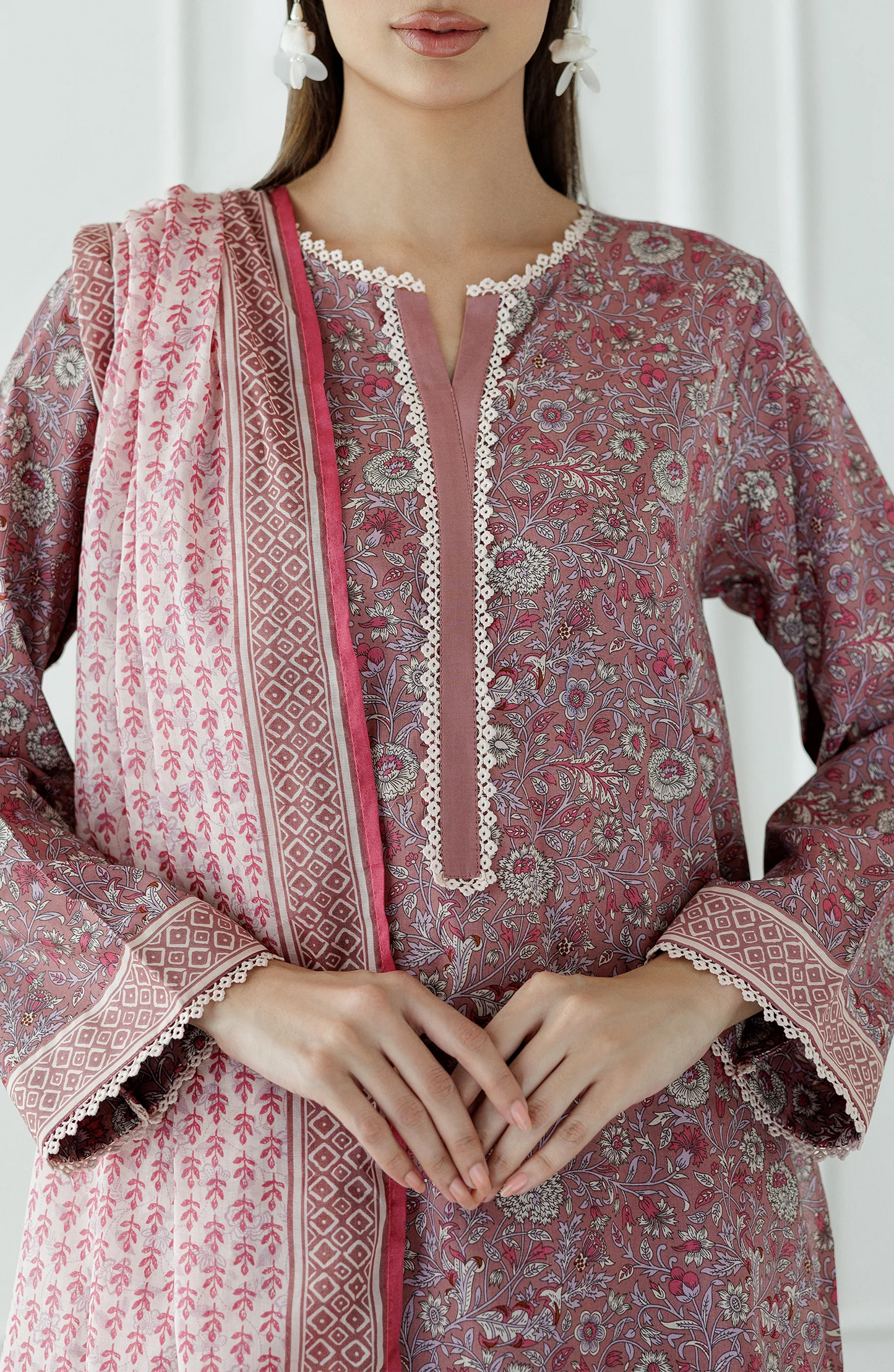 Woman wearing a pink traditional outfit with a matching dupatta against a traditional shalwar. Stitched Printed Lawn Shirt Dupatta & Pant - 3 Piece Suits - OTL-25-345