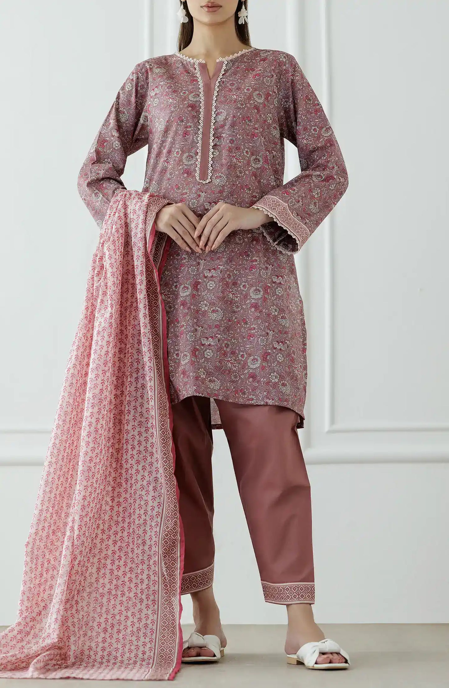Woman wearing a pink traditional outfit with a matching dupatta against a traditional shalwar. Stitched Printed Lawn Shirt Dupatta & Pant - 3 Piece Suits - OTL-25-345