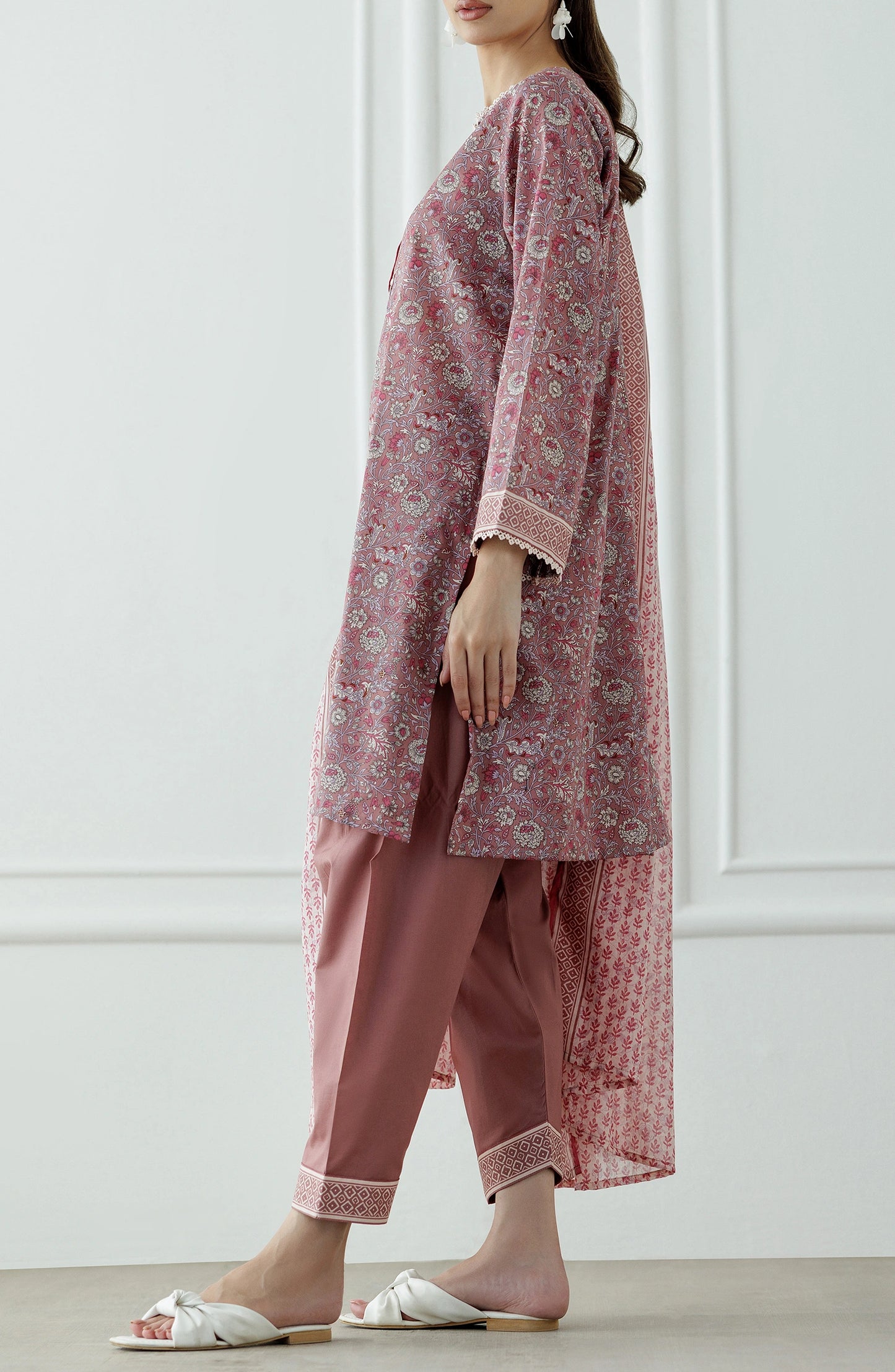 Woman wearing a pink traditional outfit with a matching dupatta against a traditional shalwar. Stitched Printed Lawn Shirt Dupatta & Pant - 3 Piece Suits - OTL-25-345