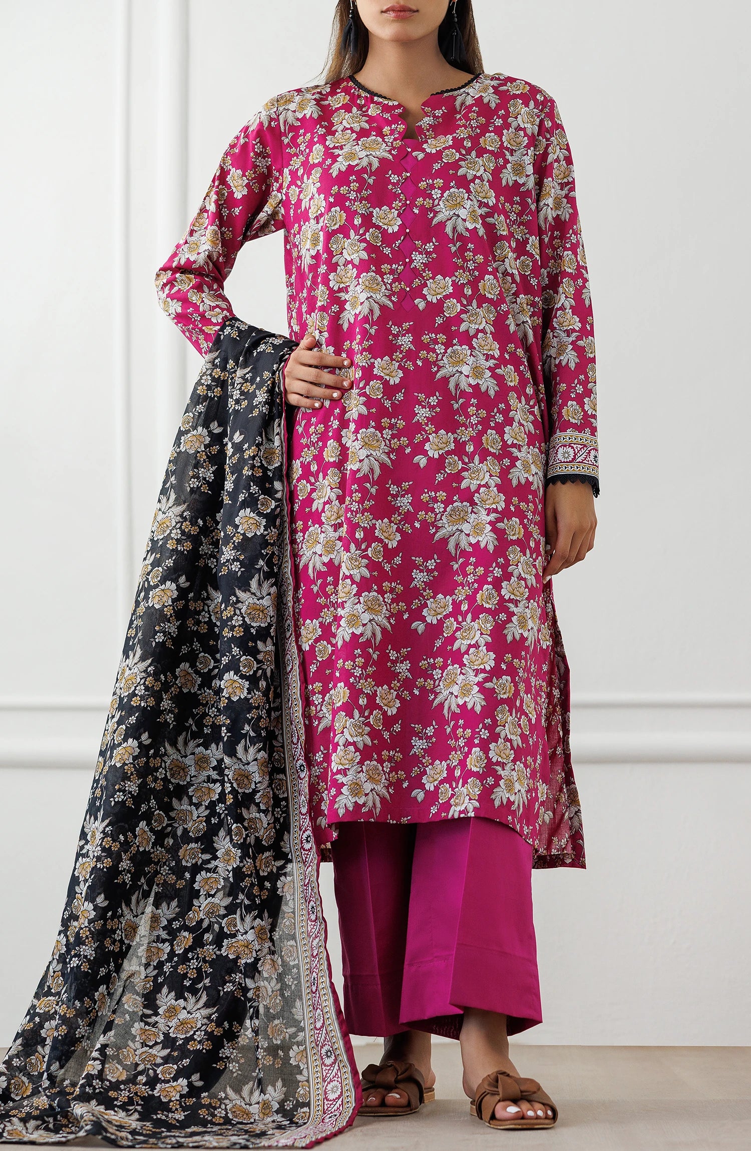 Woman wearing a pink floral kurta with matching pants and a black floral dupatta on a dyed plain trouser. Unstitched Printed Lawn Shirt Dupatta & Pant - 3 Piece Suits - OTL-25-346