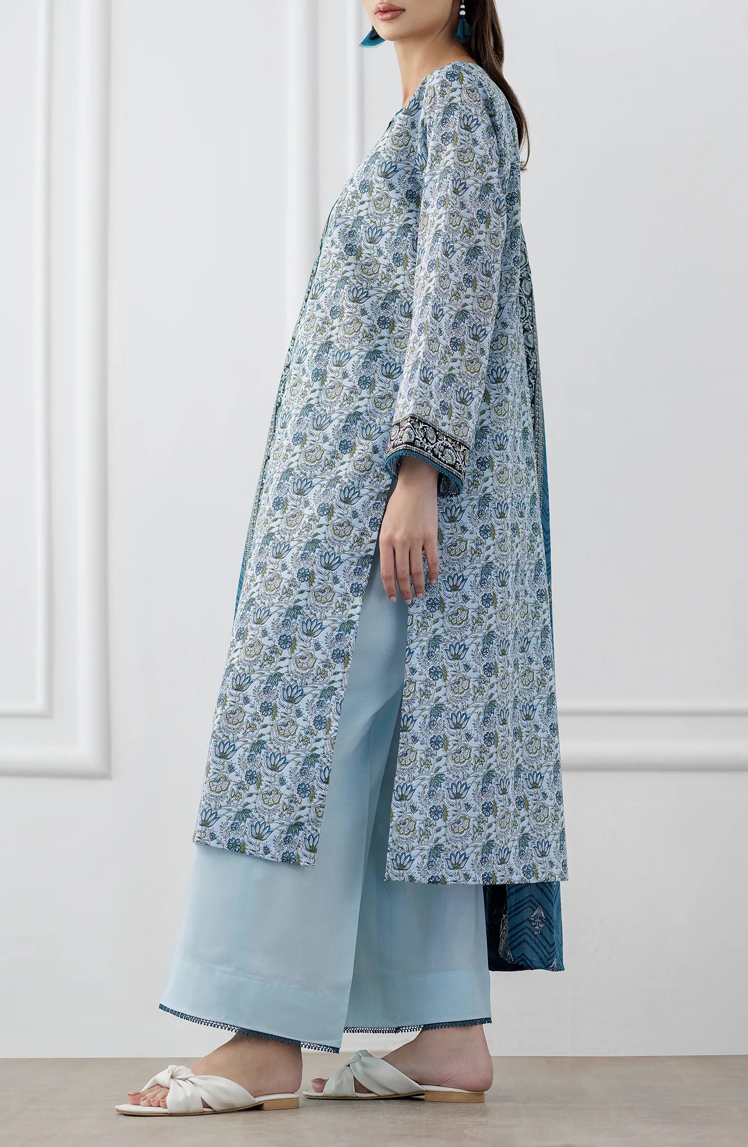 Woman wearing a blue and white patterned kurta with a matching dupatta on a dyed trouser. Stitched Printed Lawn Shirt Dupatta & Pant - 3 Piece Suits - OTL-25-347