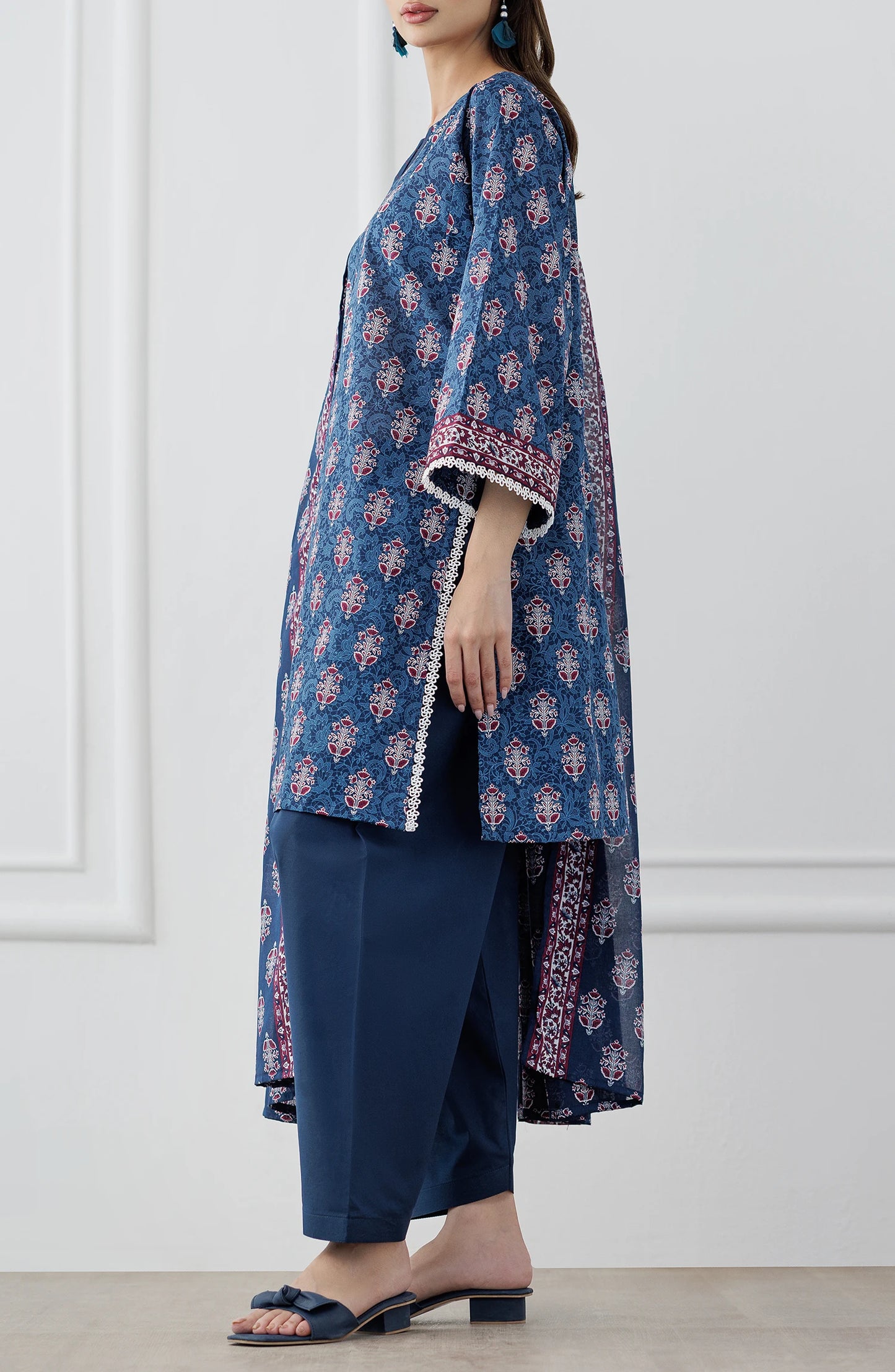 Woman wearing a blue patterned outfit with a matching dupatta on a dyed trouser. Stitched Printed Lawn Shirt Dupatta & Pant - 3 Piece Suits - OTL-25-353