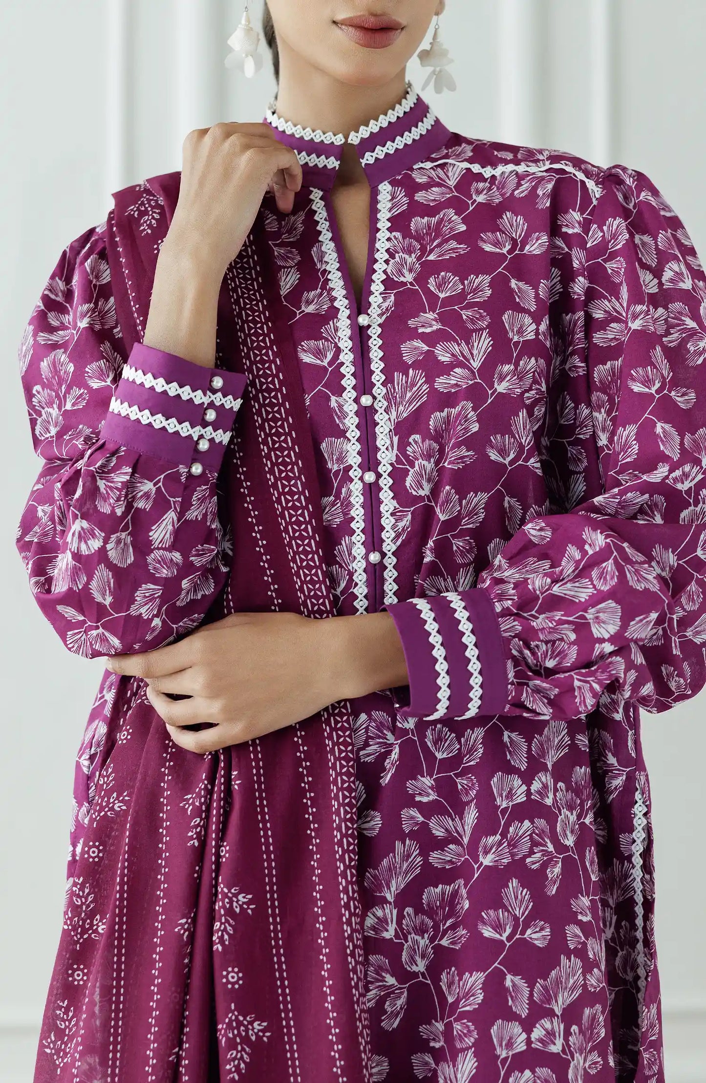 Women wearing a purple dress with white floral pattern and pearl details and dyed trouser. Stitched Printed Lawn Shirt Dupatta & Pant - 3 Piece Suits - OTL-25-378