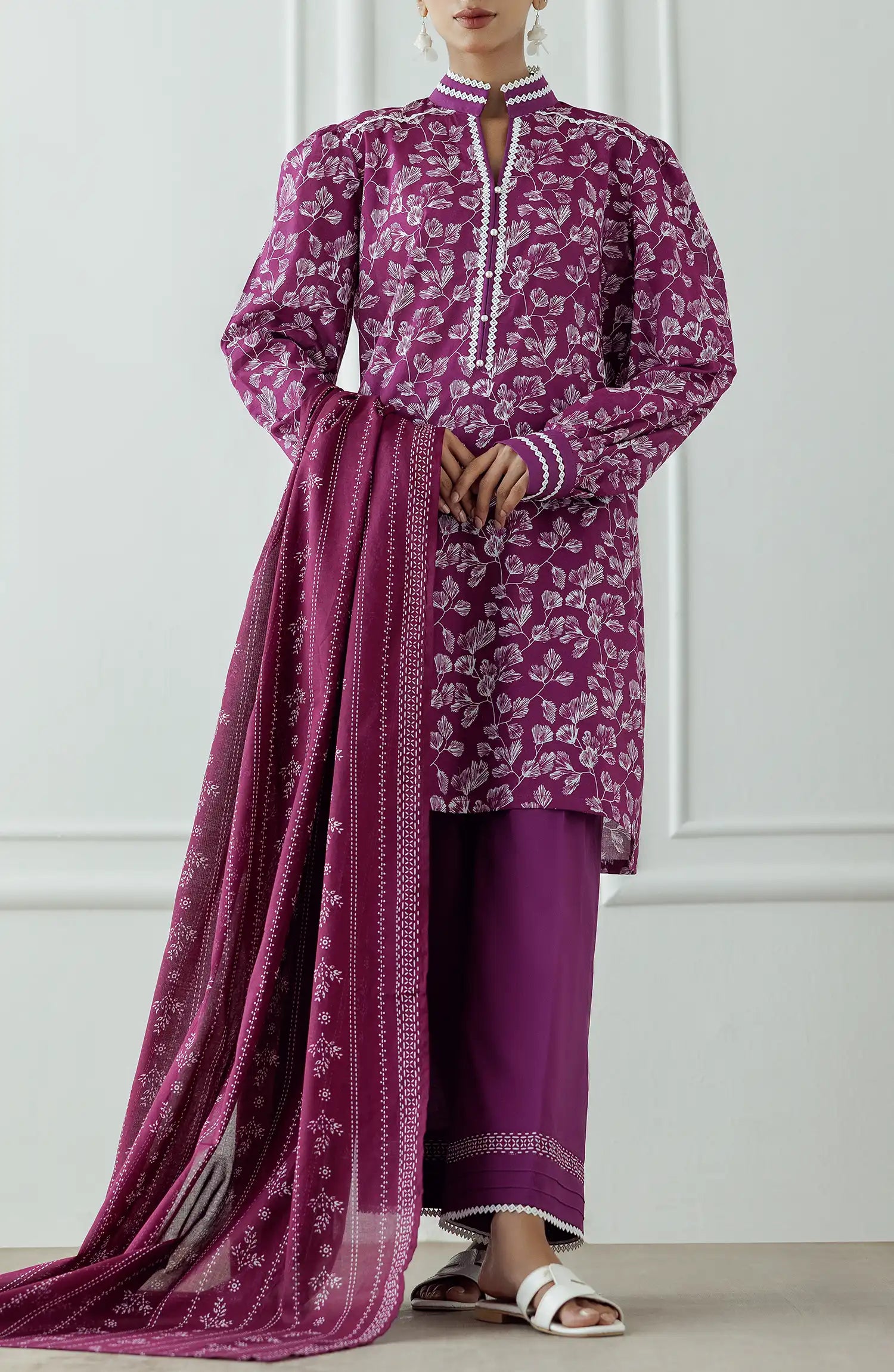Women wearing a purple dress with white floral pattern and pearl details and dyed trouser. Stitched Printed Lawn Shirt Dupatta & Pant - 3 Piece Suits - OTL-25-378