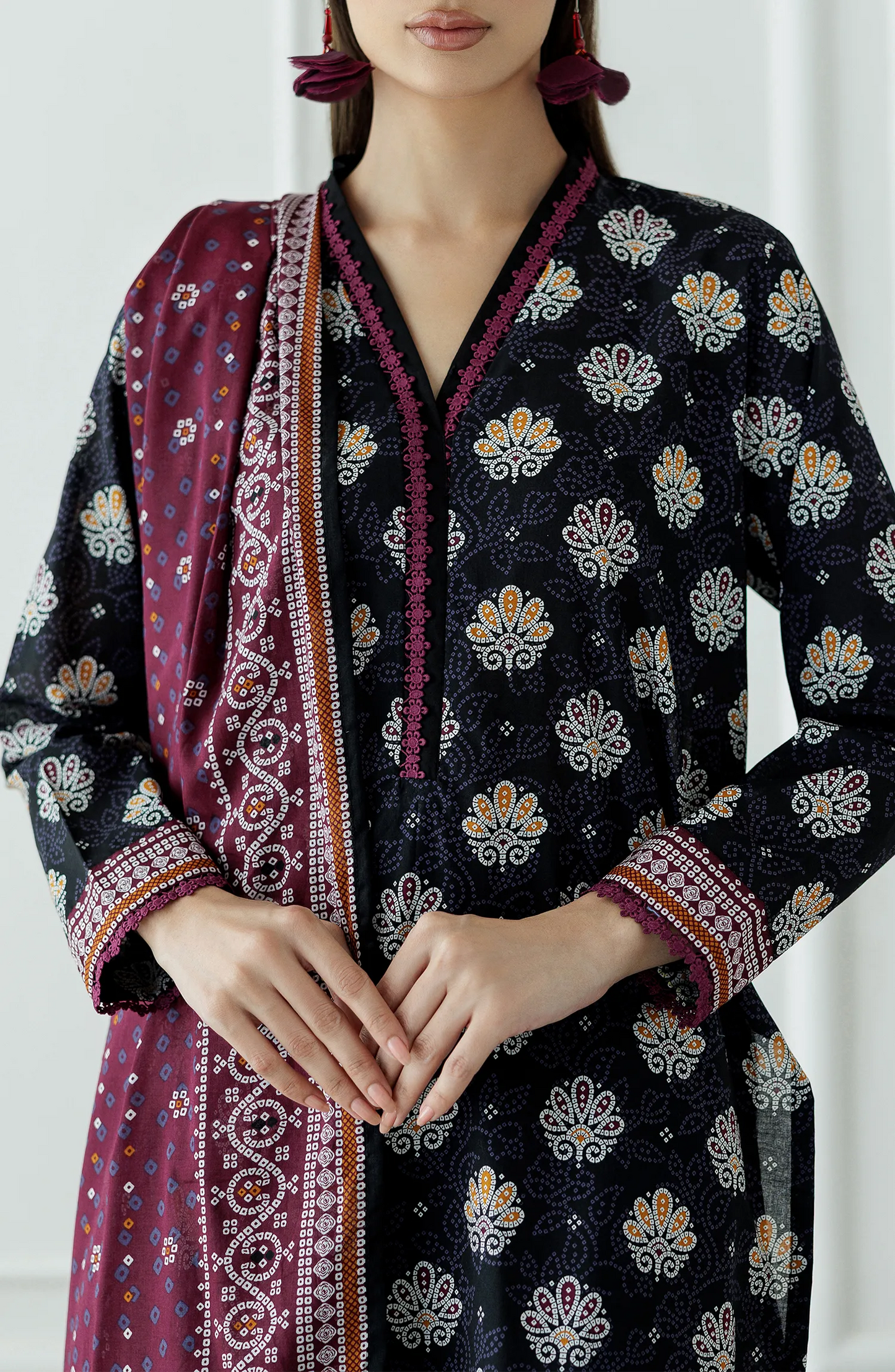 Woman wearing a dark floral patterned kurta with black pants and a matching dupatta on a dyed Trouser. Stitched Printed Lawn Shirt Dupatta & Pant - 3 Piece Suits - OTL-25-407