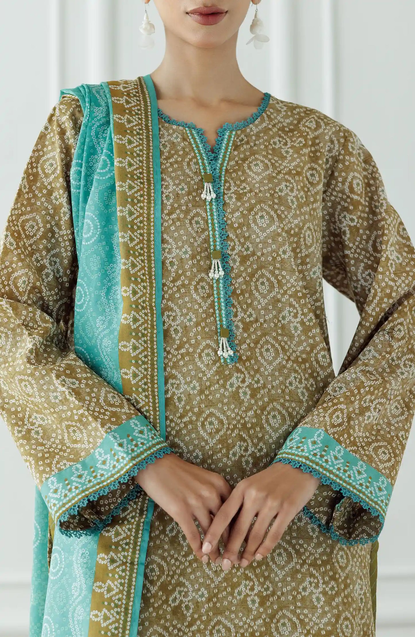 Woman wearing a patterned kurta with green dupatta against a dyed trouser. Stitched Printed Lawn Shirt Dupatta & Pant - 3 Piece Suits - OTL-25-408