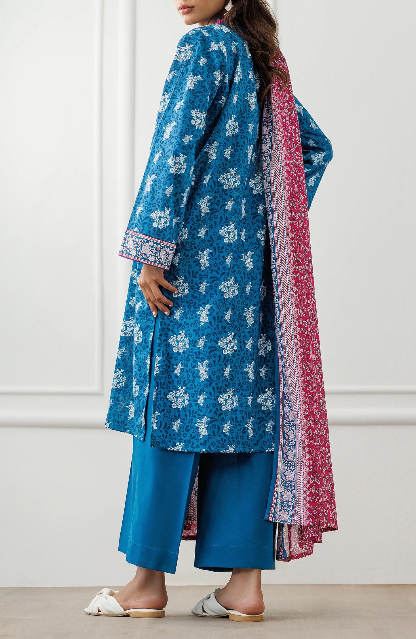 Woman wearing a blue floral dress with a pink dupatta against a matching trouser. Unstitched Printed Lawn Shirt Dupatta & Pant - 3 Piece Suits - OTL-25-477