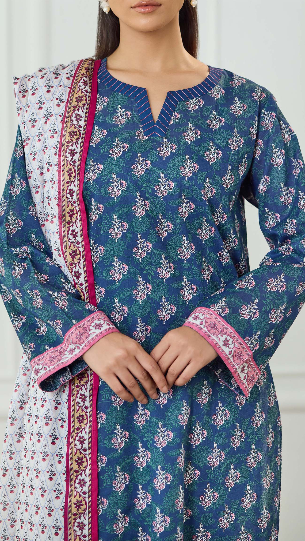 Woman wearing a blue printed kurta with a matching dupatta on a plain trouser. Unstitched Printed Lawn Shirt Dupatta & Pant - 3 Piece Suits - OTL-25-500