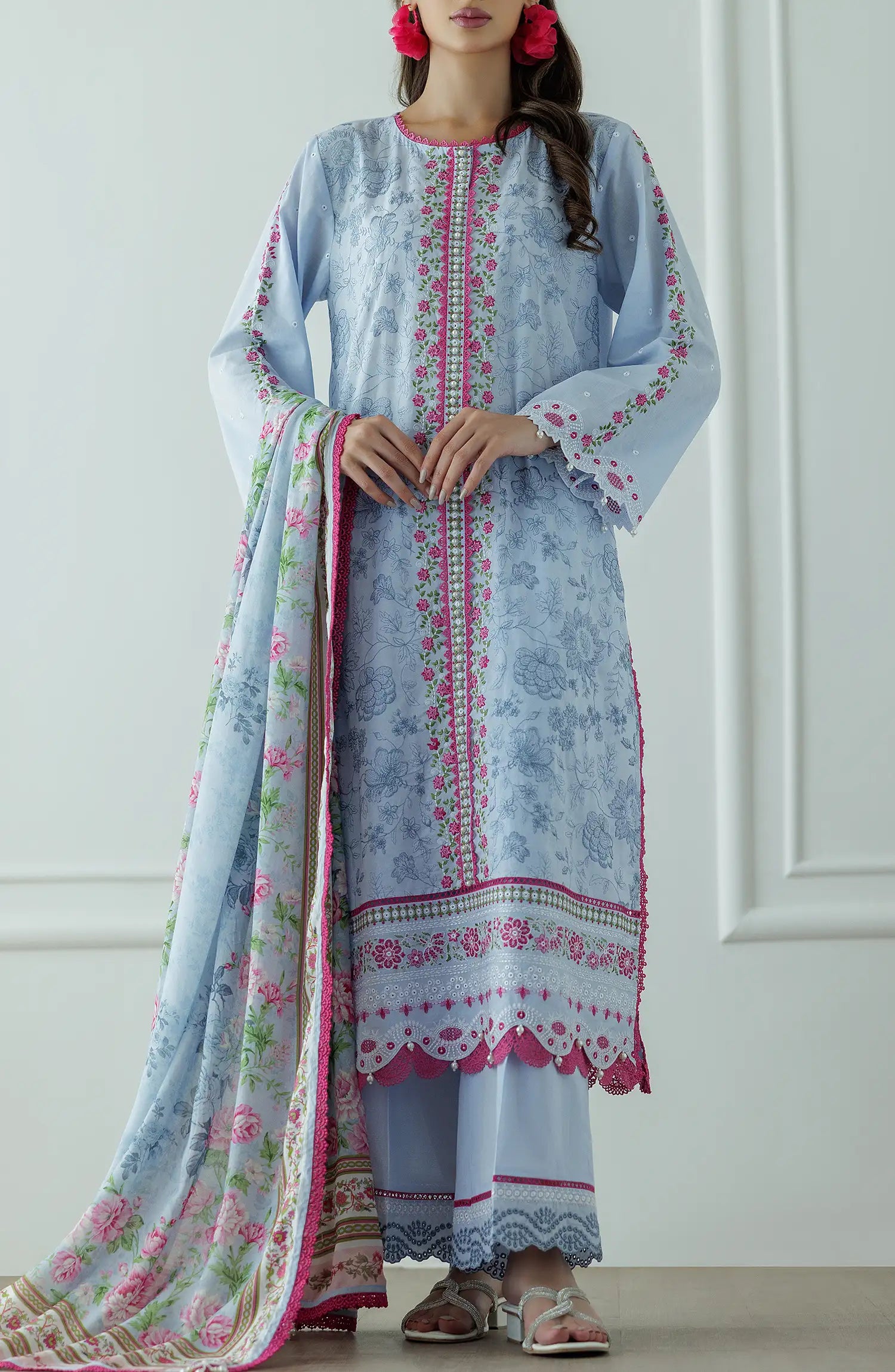 Woman wearing a light blue embroidered outfit with a floral dupatta against a dyed trouser. Stitched Luxury Premium Embroidered Lawn Shirt Dupatta & Pant - 3 Piece Suits - WRC25S-3008