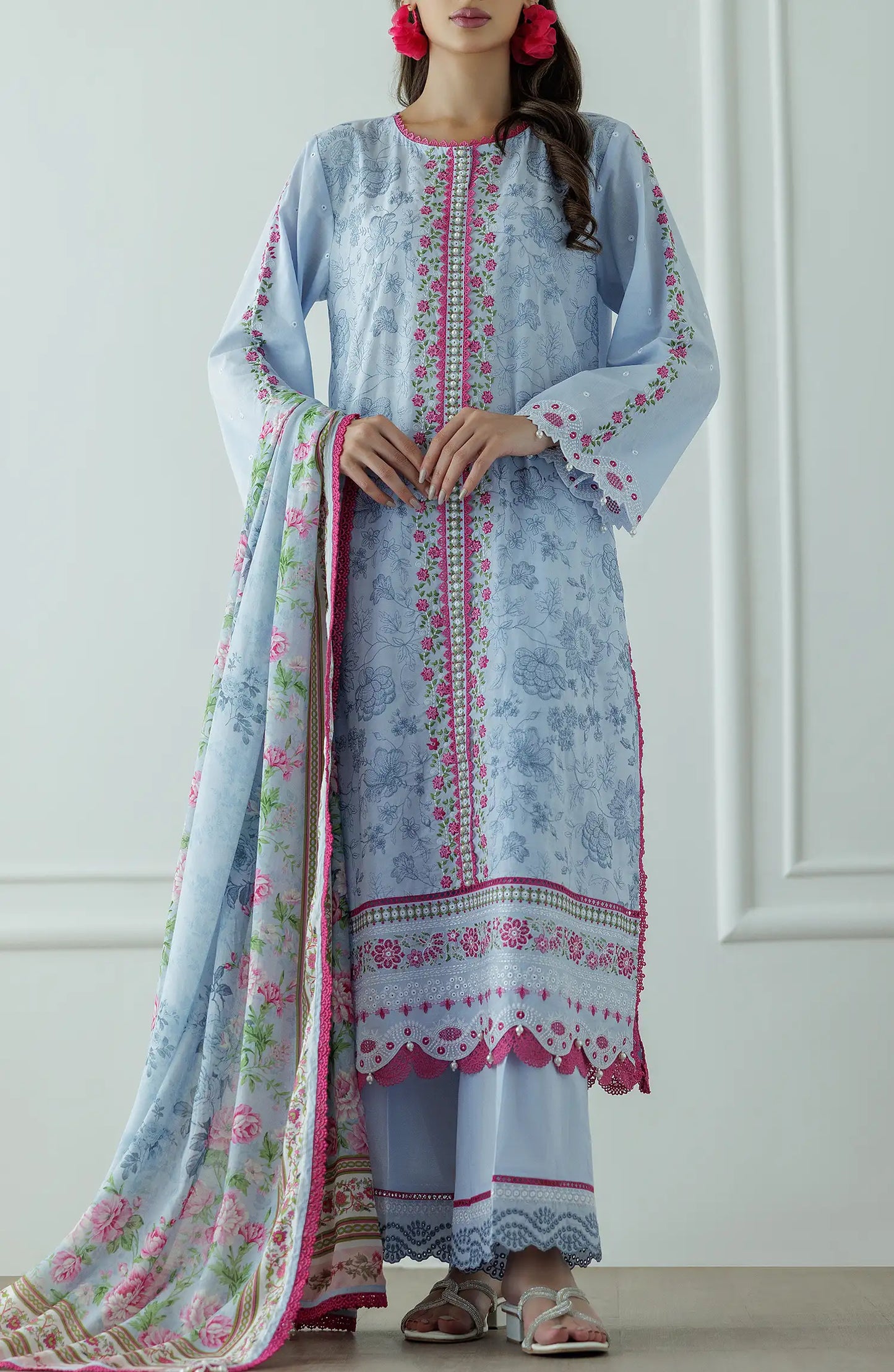 Woman wearing a light blue embroidered outfit with a floral dupatta against a dyed trouser. Stitched Luxury Premium Embroidered Lawn Shirt Dupatta & Pant - 3 Piece Suits - WRC25S-3008