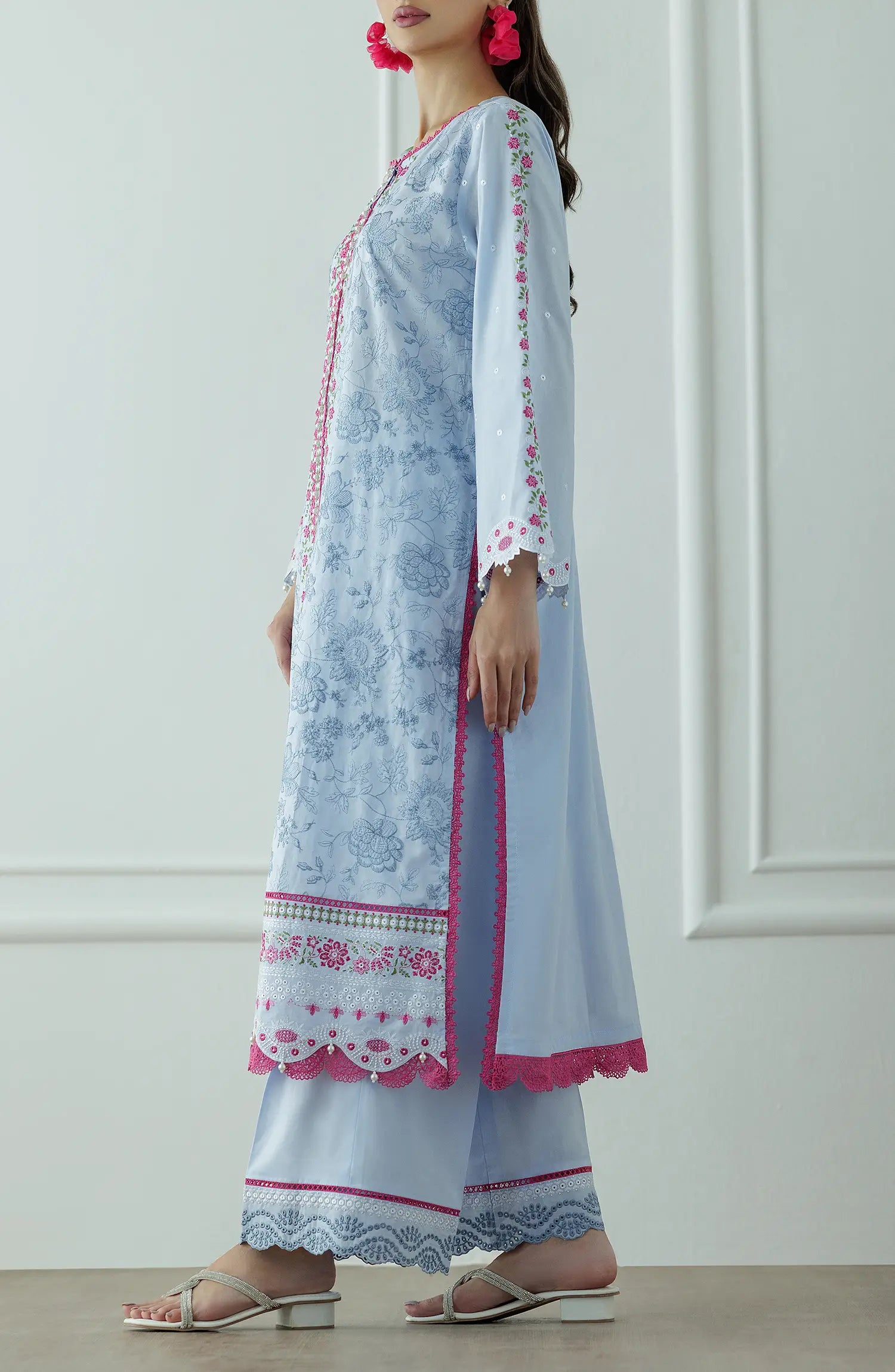 Woman wearing a light blue embroidered outfit with a floral dupatta against a dyed trouser. Stitched Luxury Premium Embroidered Lawn Shirt Dupatta & Pant - 3 Piece Suits - WRC25S-3008