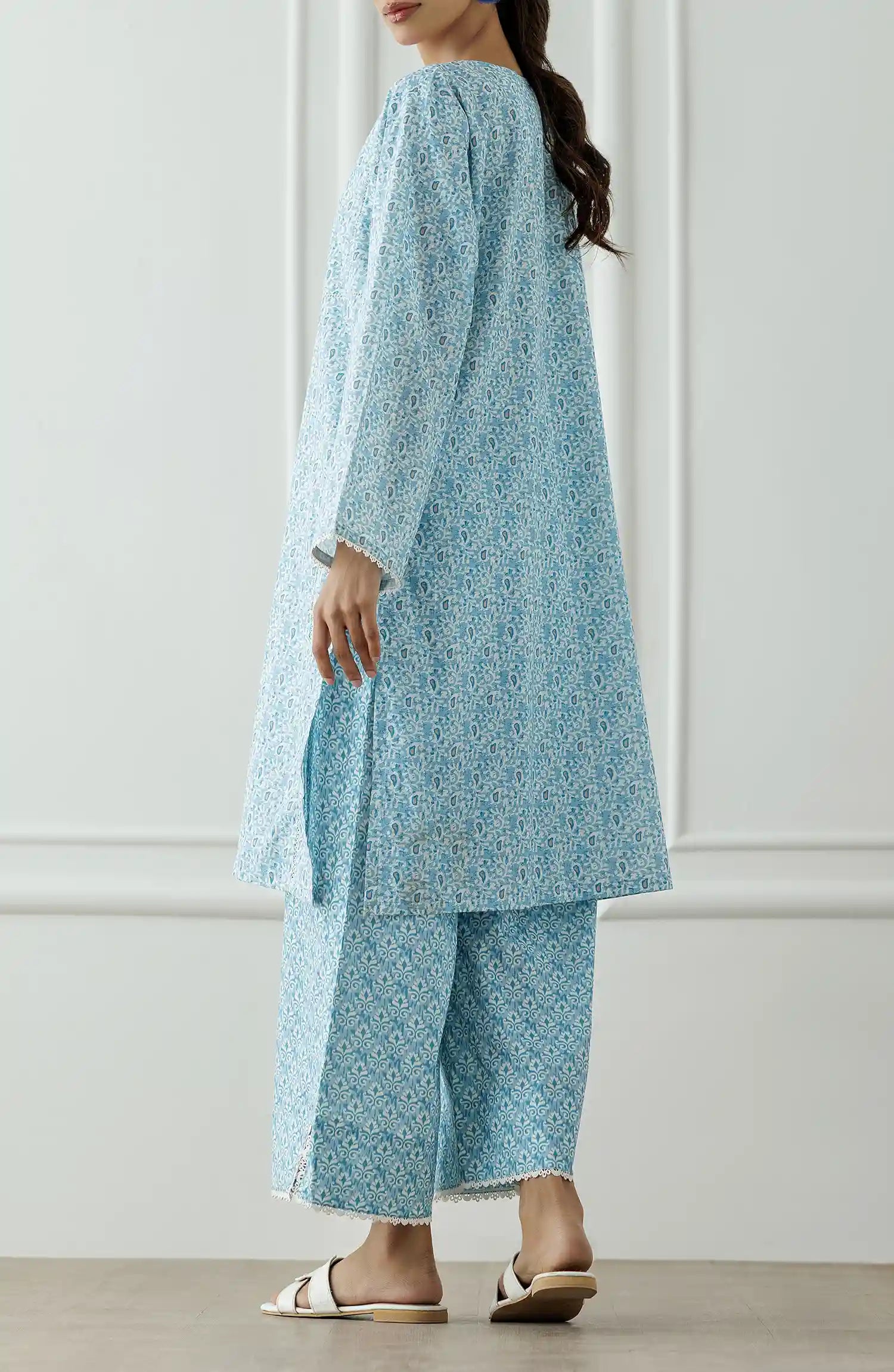 Women wearing a Light blue patterned outfit worn by a person against a printed trouser. Stitched Printed Lawn Shirt & Pant - 2 Piece Suits (Co-ord Set) - WRCV25S-2007