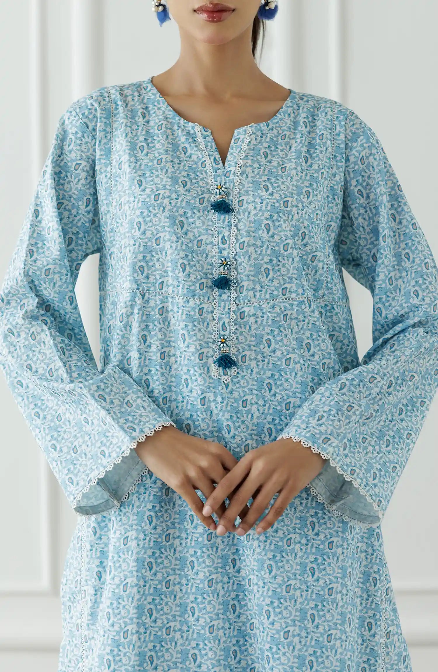 Women wearing a Light blue patterned outfit worn by a person against a printed trouser. Stitched Printed Lawn Shirt & Pant - 2 Piece Suits (Co-ord Set) - WRCV25S-2007