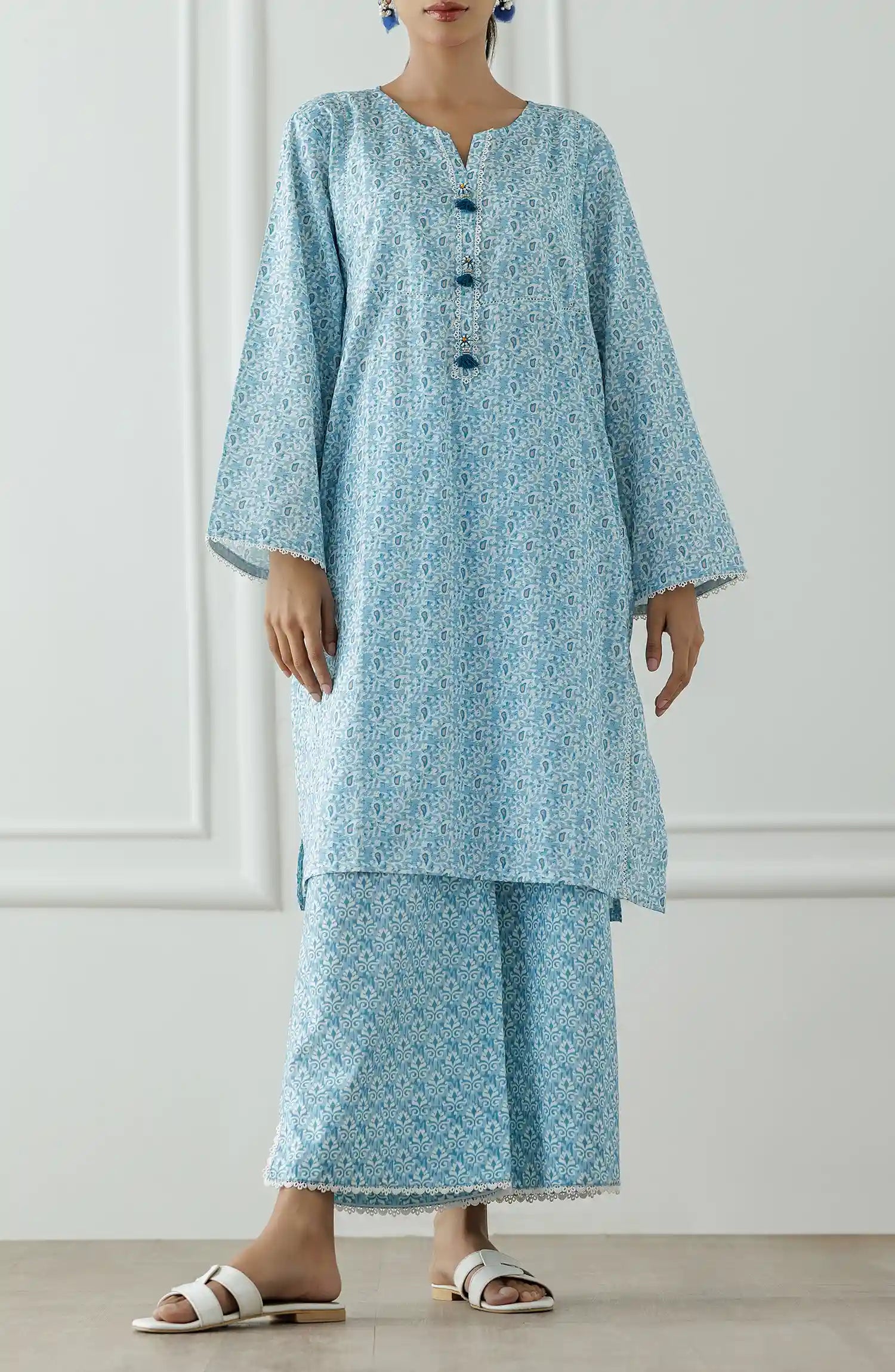 Women wearing a Light blue patterned outfit worn by a person against a printed trouser. Stitched Printed Lawn Shirt & Pant - 2 Piece Suits (Co-ord Set) - WRCV25S-2007