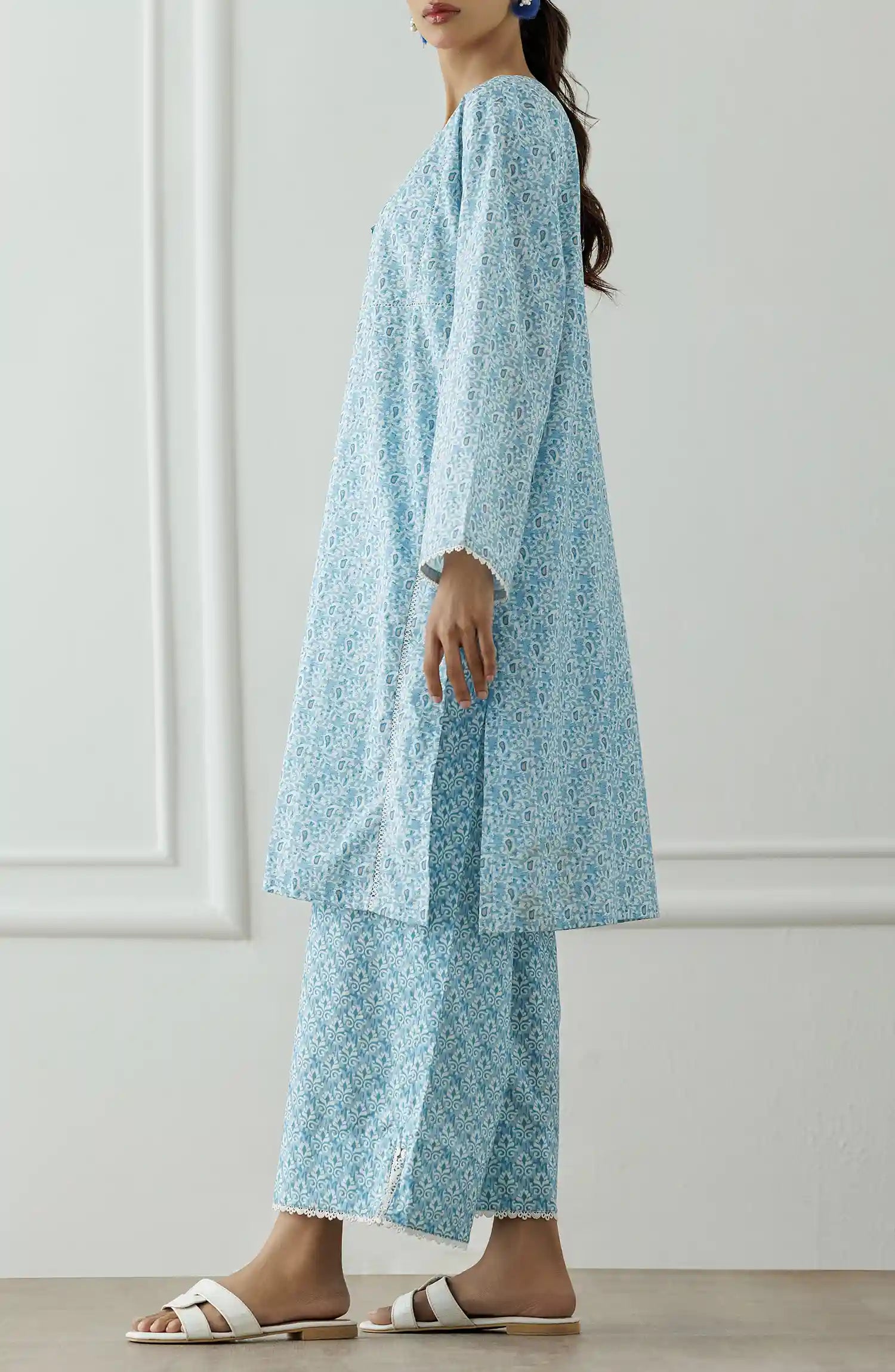 Women wearing a Light blue patterned outfit worn by a person against a printed trouser. Stitched Printed Lawn Shirt & Pant - 2 Piece Suits (Co-ord Set) - WRCV25S-2007