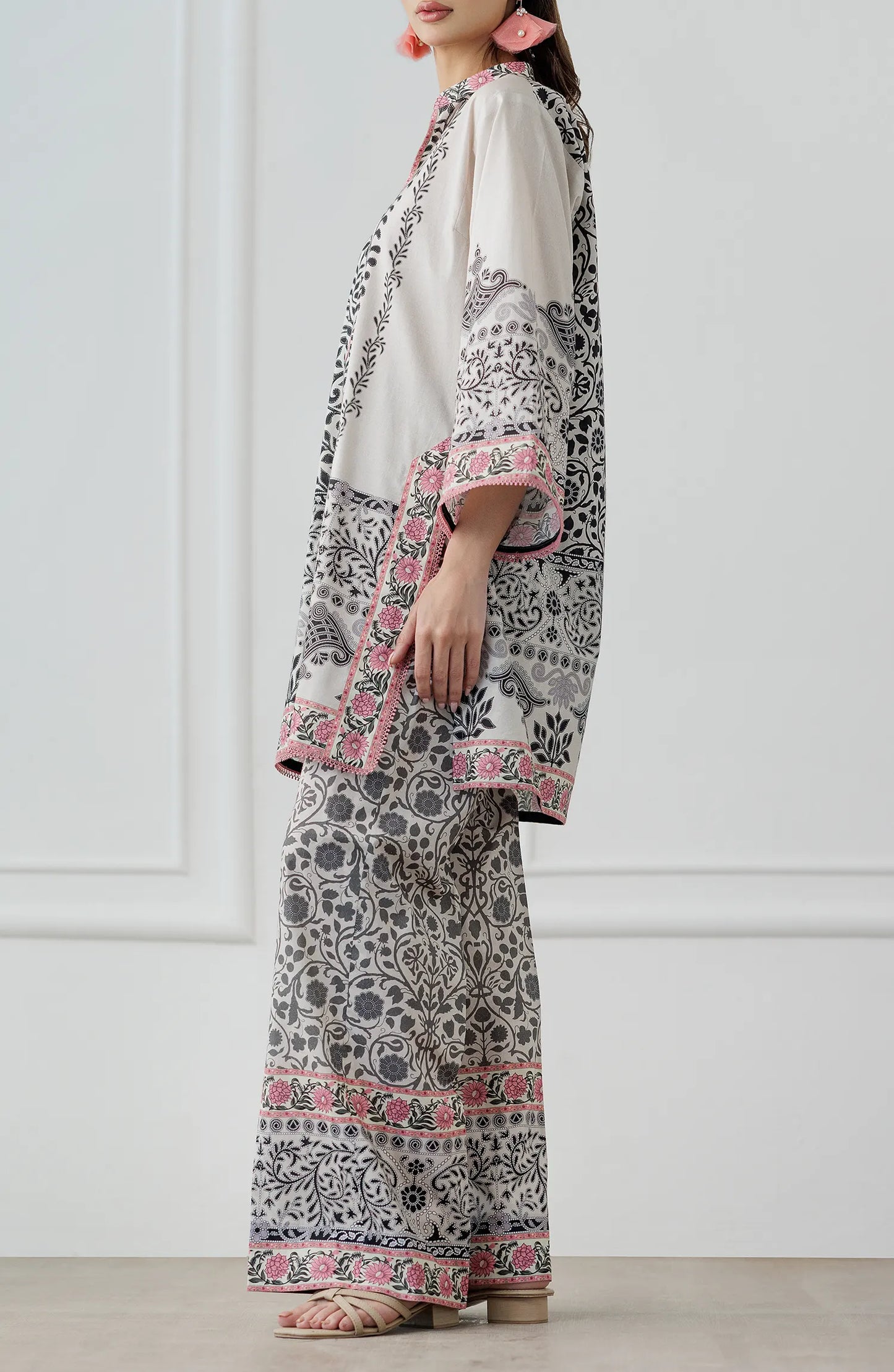Women wearing a patterned white outfit with matching trouser. Stitched Printed Lawn Shirt & Pant - 2 Piece Suits (Co-ord Set) - WRCV25S-2028