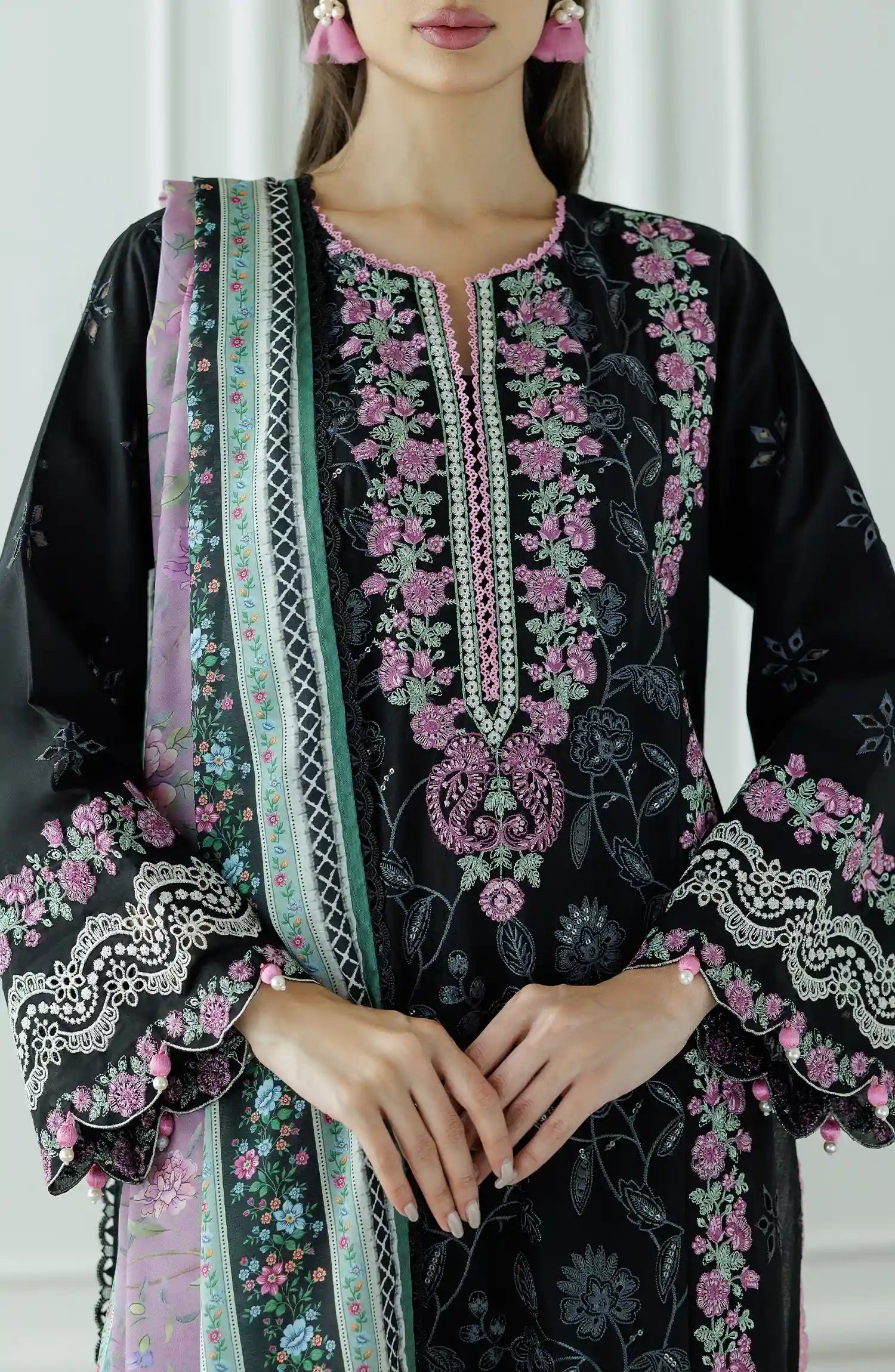 Woman wearing a black embroidered dress with pink and green dupatta against a dyed trouser. Stitched Luxury Premium Embroidered Lawn Shirt Dupatta & Pant - 3 Piece Suits - WRFC25S-3010