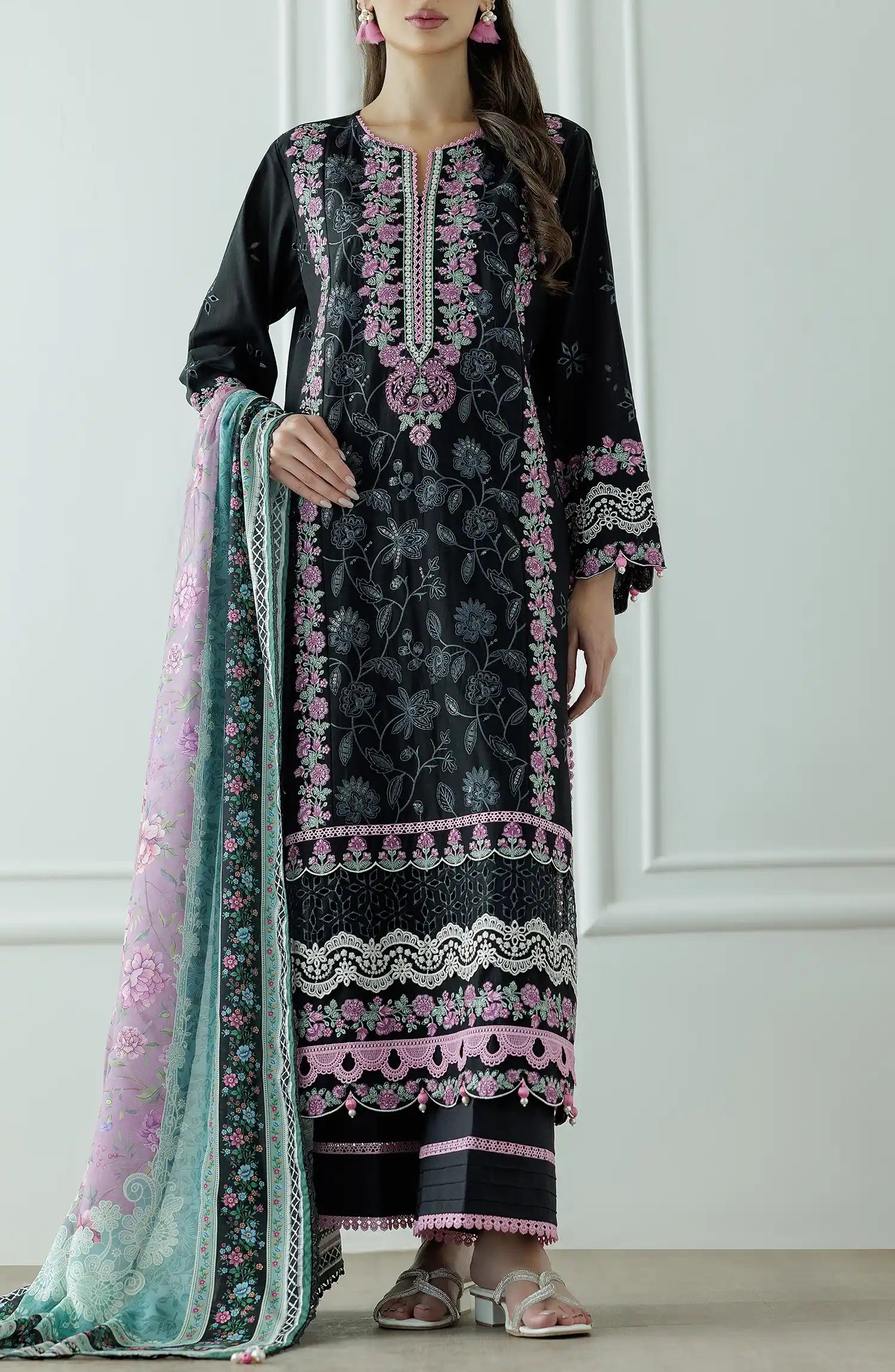 Woman wearing a black embroidered dress with pink and green dupatta against a dyed trouser. Stitched Luxury Premium Embroidered Lawn Shirt Dupatta & Pant - 3 Piece Suits - WRFC25S-3010