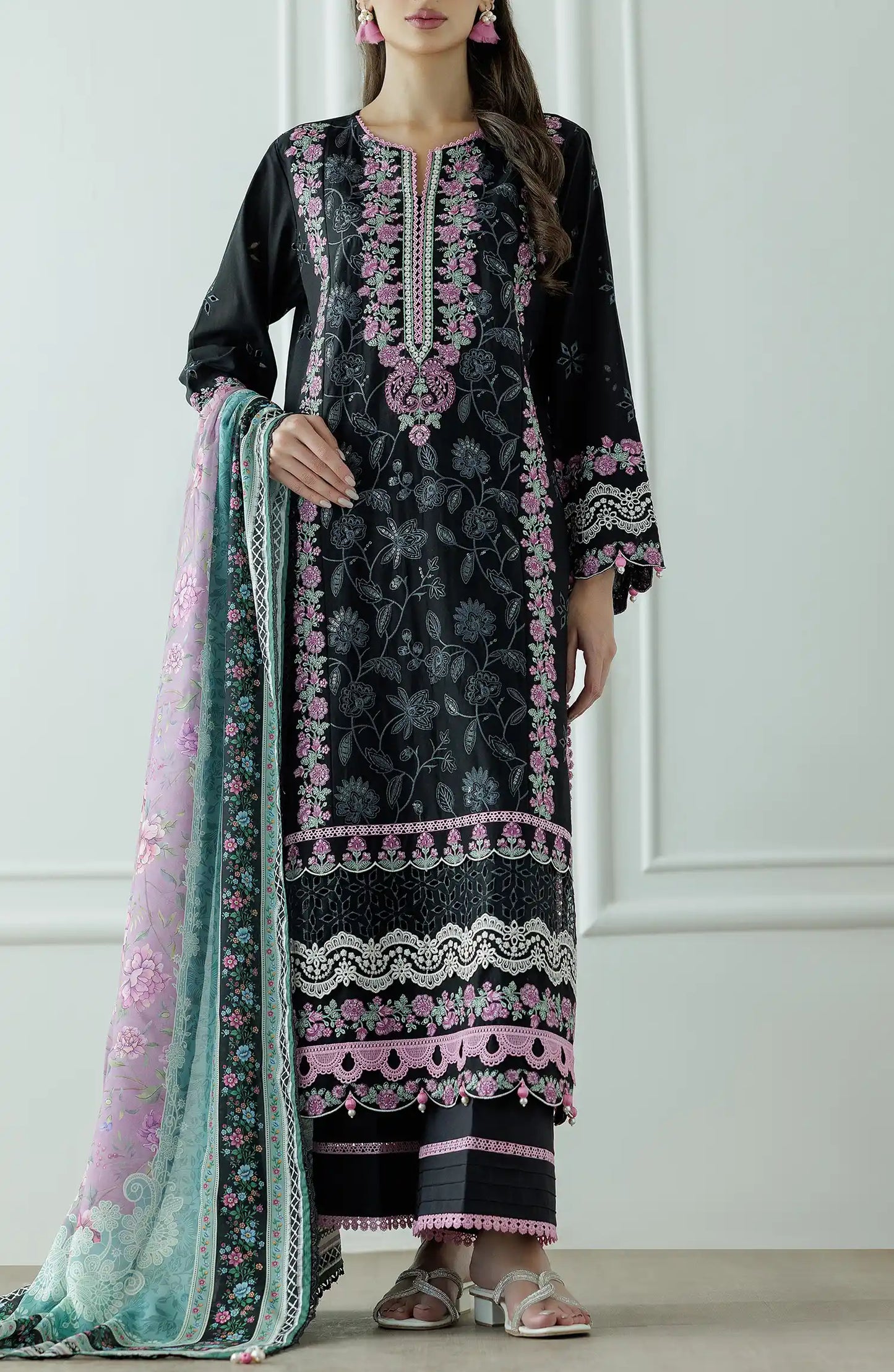 Woman wearing a black embroidered dress with pink and green dupatta against a dyed trouser. Stitched Luxury Premium Embroidered Lawn Shirt Dupatta & Pant - 3 Piece Suits - WRFC25S-3010