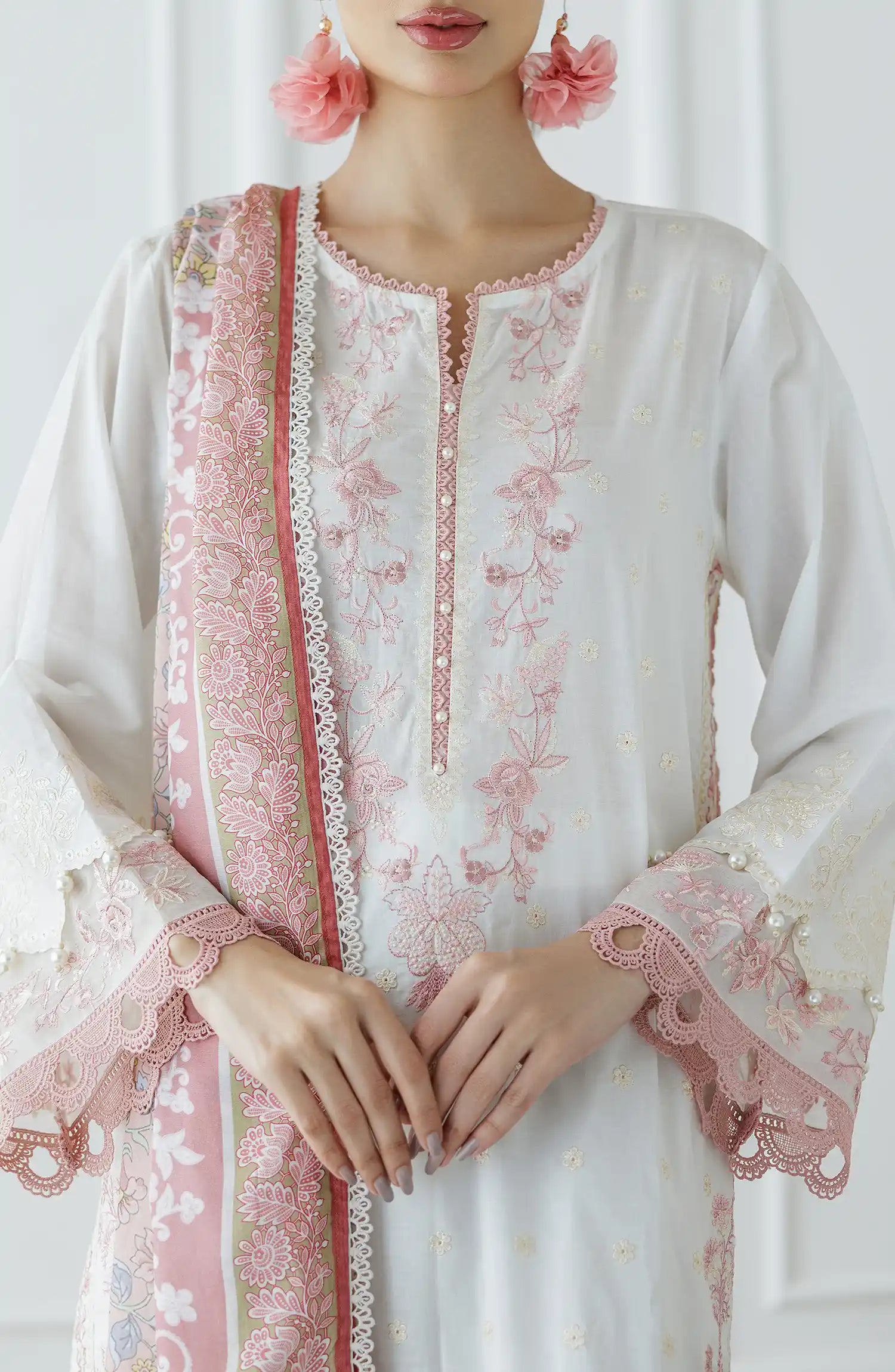 Woman wearing a white and pink embroidered traditional outfit with a matching dupatta against a dyed trouser. Stitched Luxury Festive Formal Lawn Shirt Dupatta & Pant - 3 Piece Suits - WRFC25S-3030