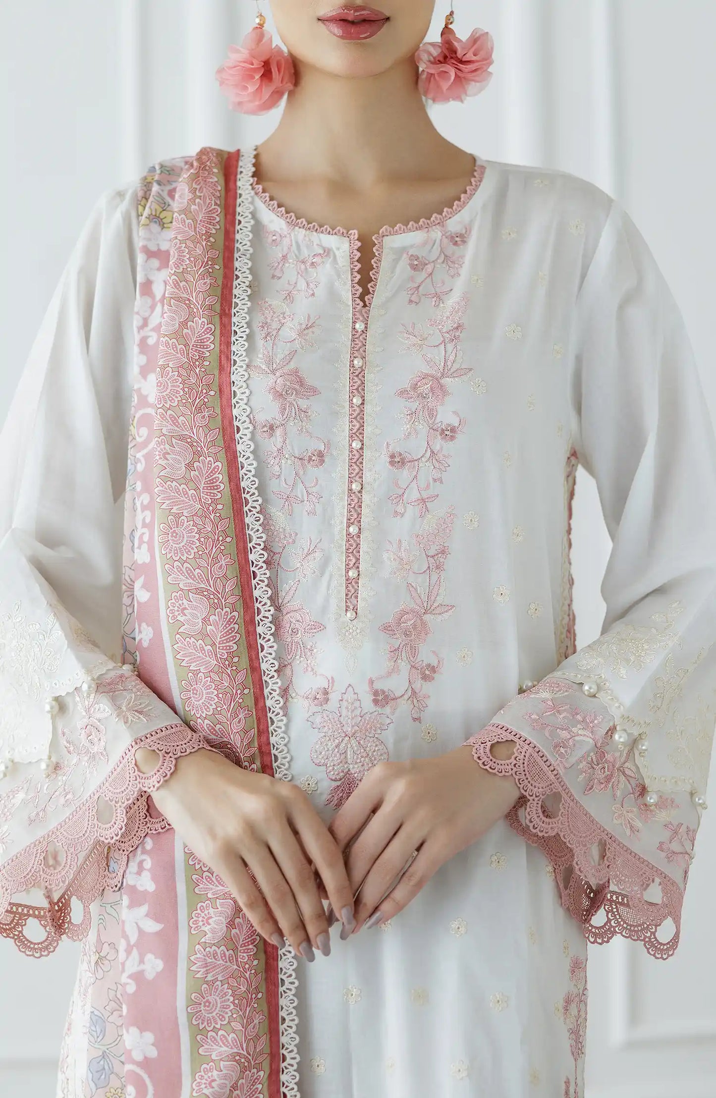 Woman wearing a white and pink embroidered traditional outfit with a matching dupatta against a dyed trouser. Stitched Luxury Festive Formal Lawn Shirt Dupatta & Pant - 3 Piece Suits - WRFC25S-3030