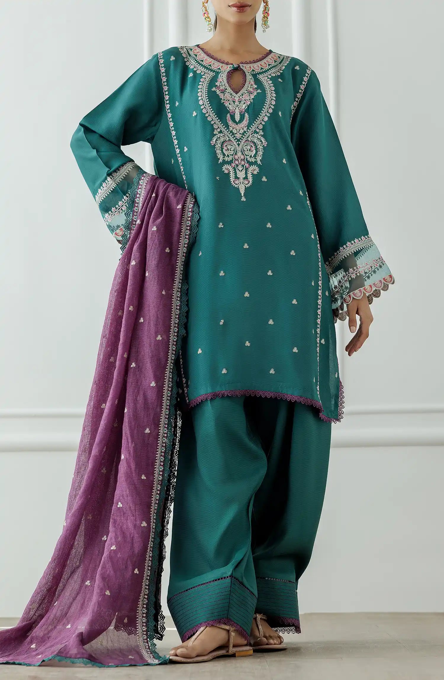 Women wearing a embroidered Teal traditional outfit with purple dupatta against a dyed trouser. WRFR24S-3013
