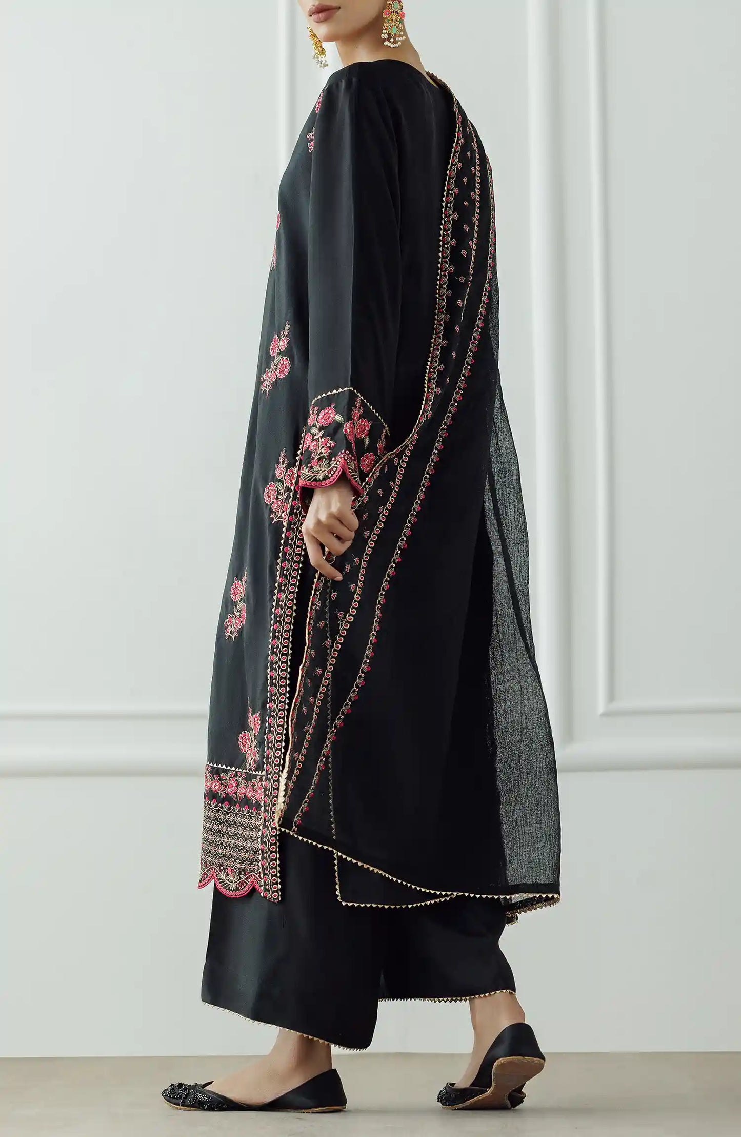 Women wearing a Black embroidered dress with pink floral patterns on a dyed trouser. Stitched Luxury Festive Formal Raw Silk Shirt Dupatta & Pant - 3 Piece Suits - WRFR24S-3017