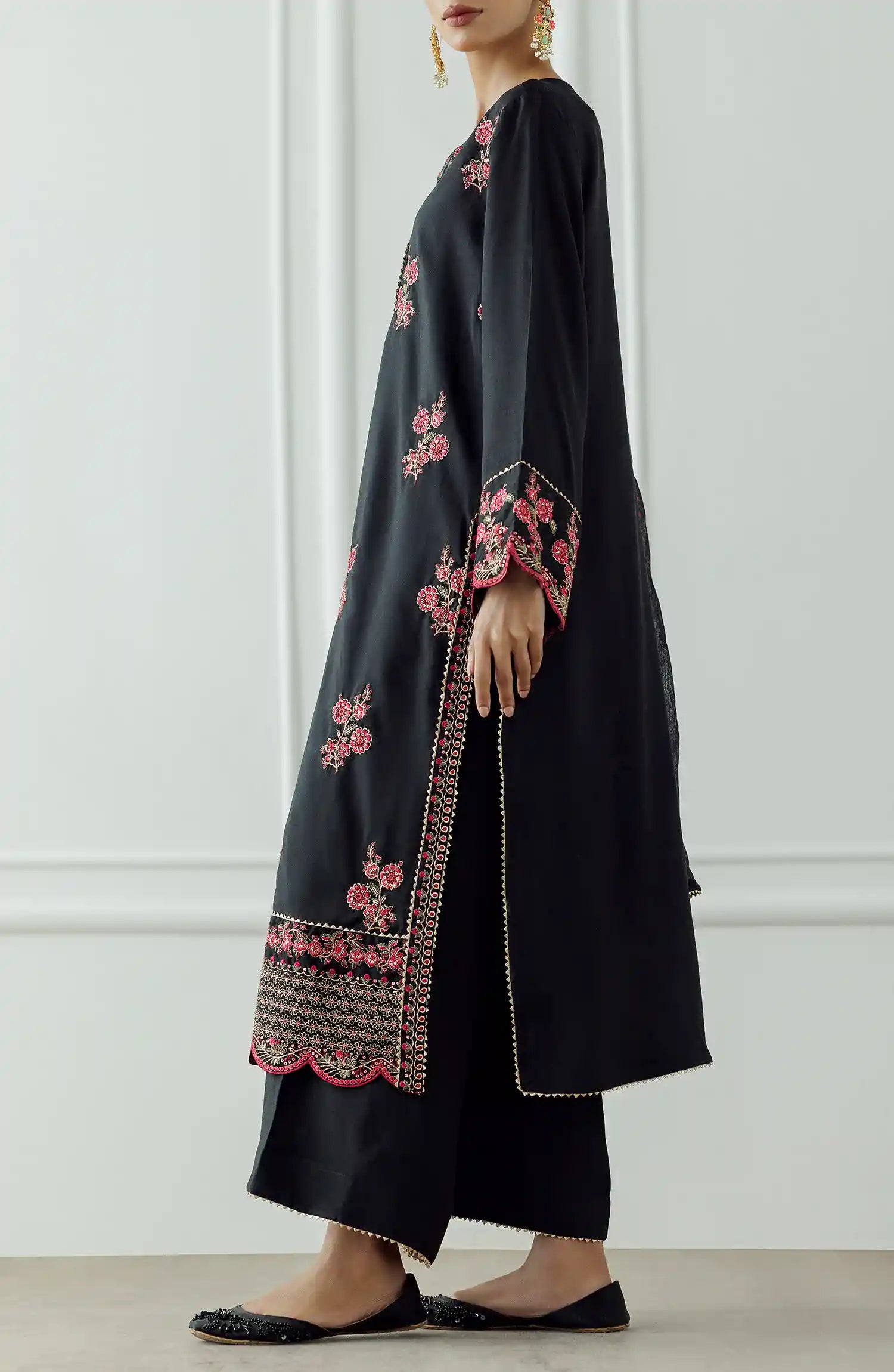 Women wearing a Black embroidered dress with pink floral patterns on a dyed trouser. Stitched Luxury Festive Formal Raw Silk Shirt Dupatta & Pant - 3 Piece Suits - WRFR24S-3017