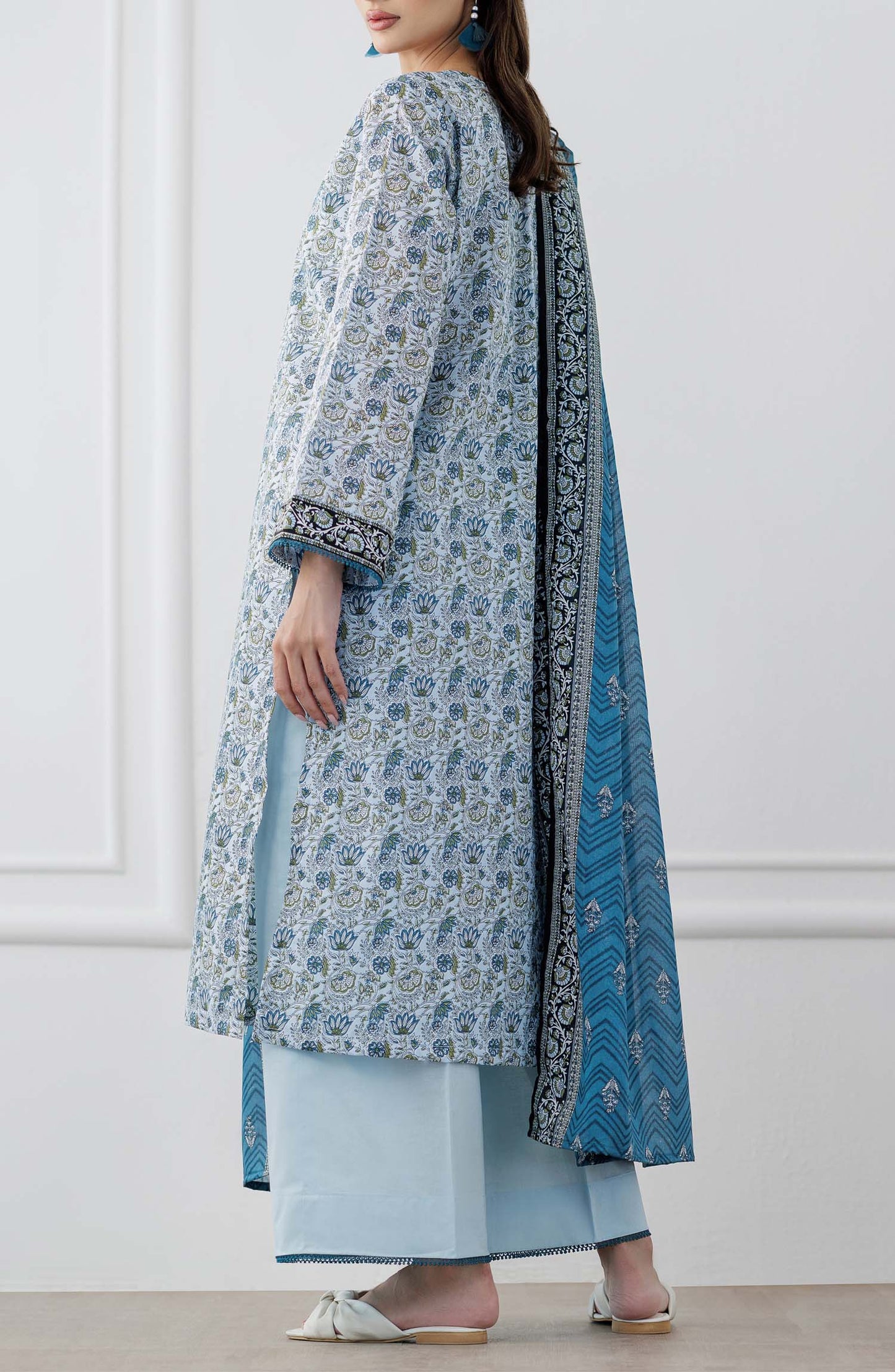 UNSTITCHED Printed Lawn Shirt Dupatta & Pant - 3 Piece Suits - OTL-25-347. Woman wearing a blue and white patterned kurta with a matching dupatta and dyed trouser.